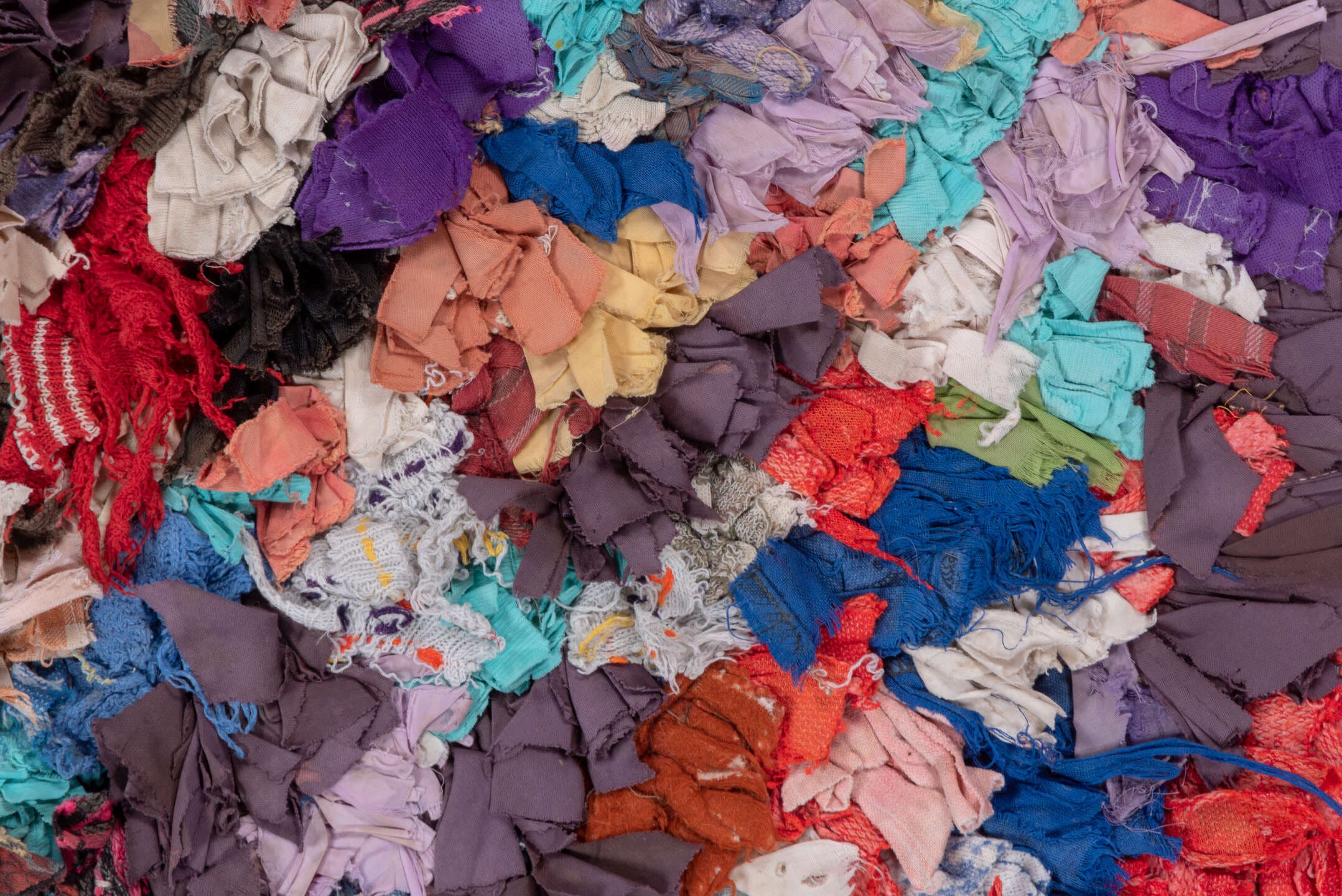 4' x 7' one-of-a-kind handmade vintage Rag Rug rug. Color palette: ivory, gray, blue, pink, purple, red, yellow, charcoal