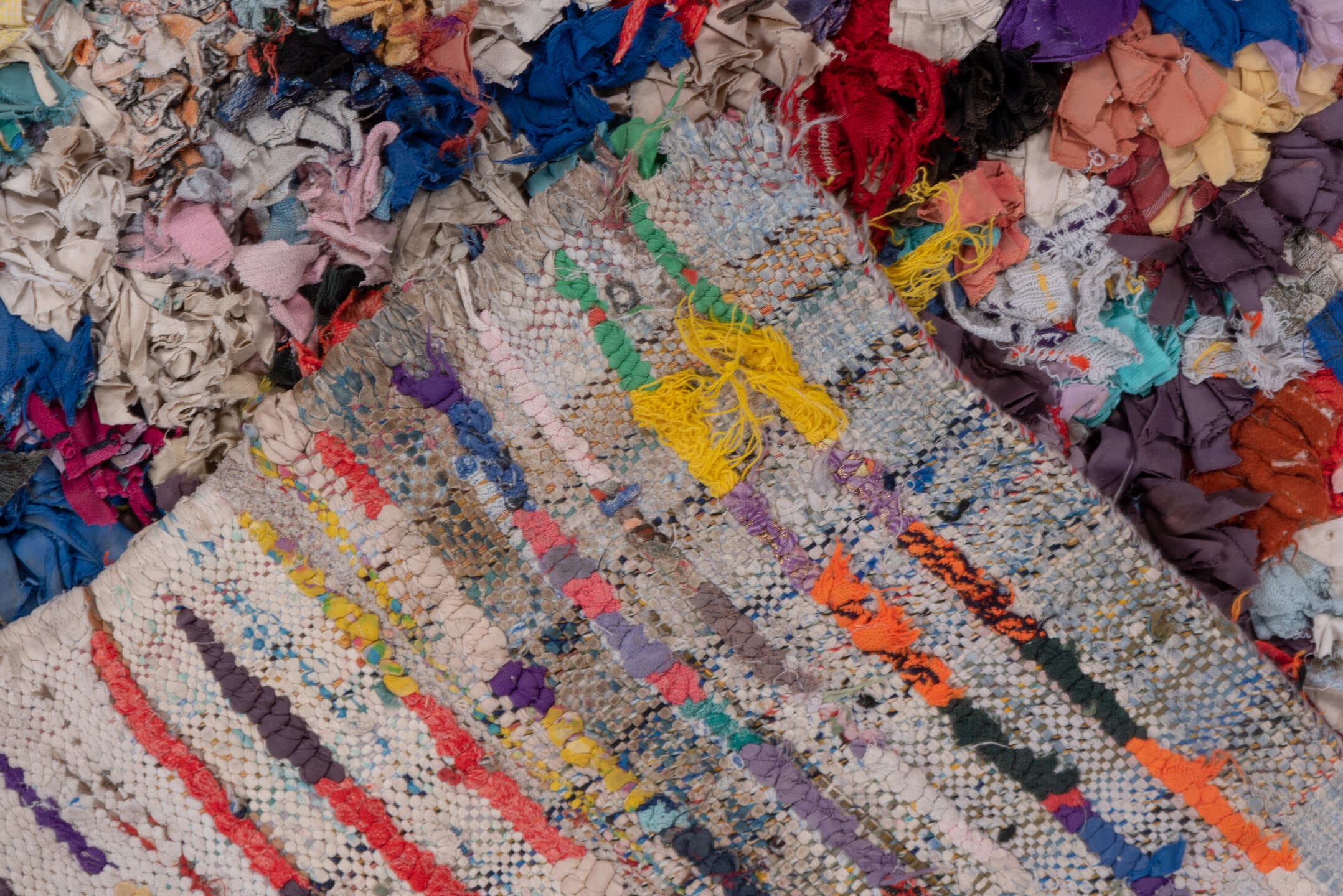 4' x 7' one-of-a-kind handmade vintage Rag Rug rug. Color palette: ivory, gray, blue, pink, purple, red, yellow, charcoal