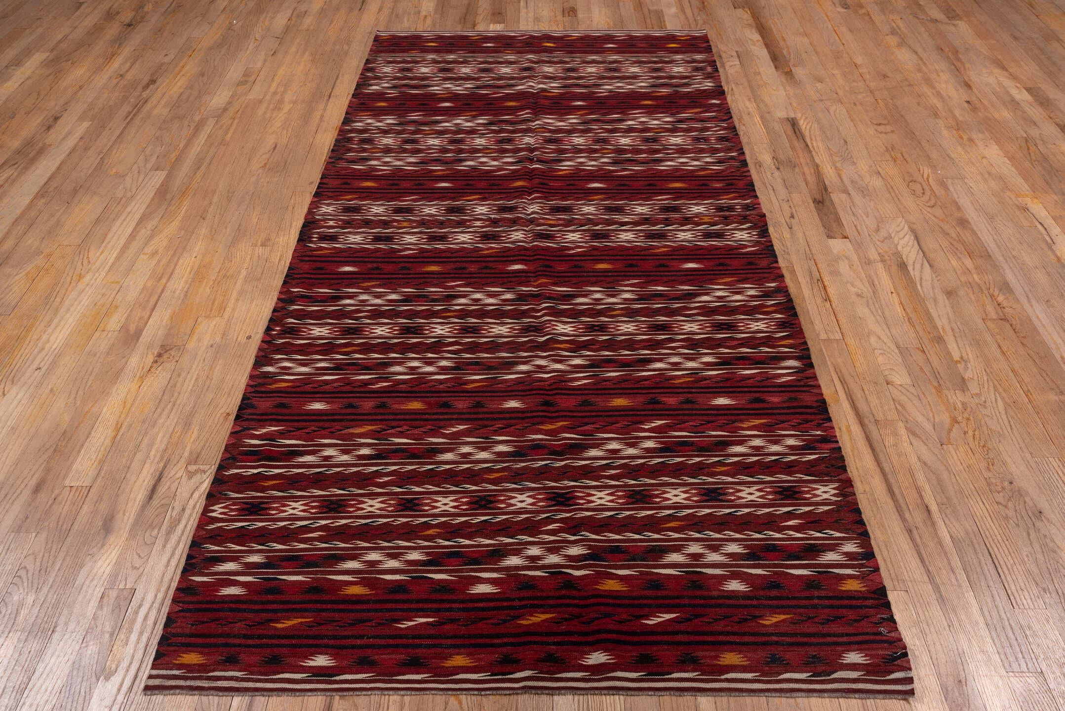 4' x 9' one-of-a-kind handmade vintage Kilim runner rug. Color palette: rust, burgundy, ivory, charcoal, gold, mahogany