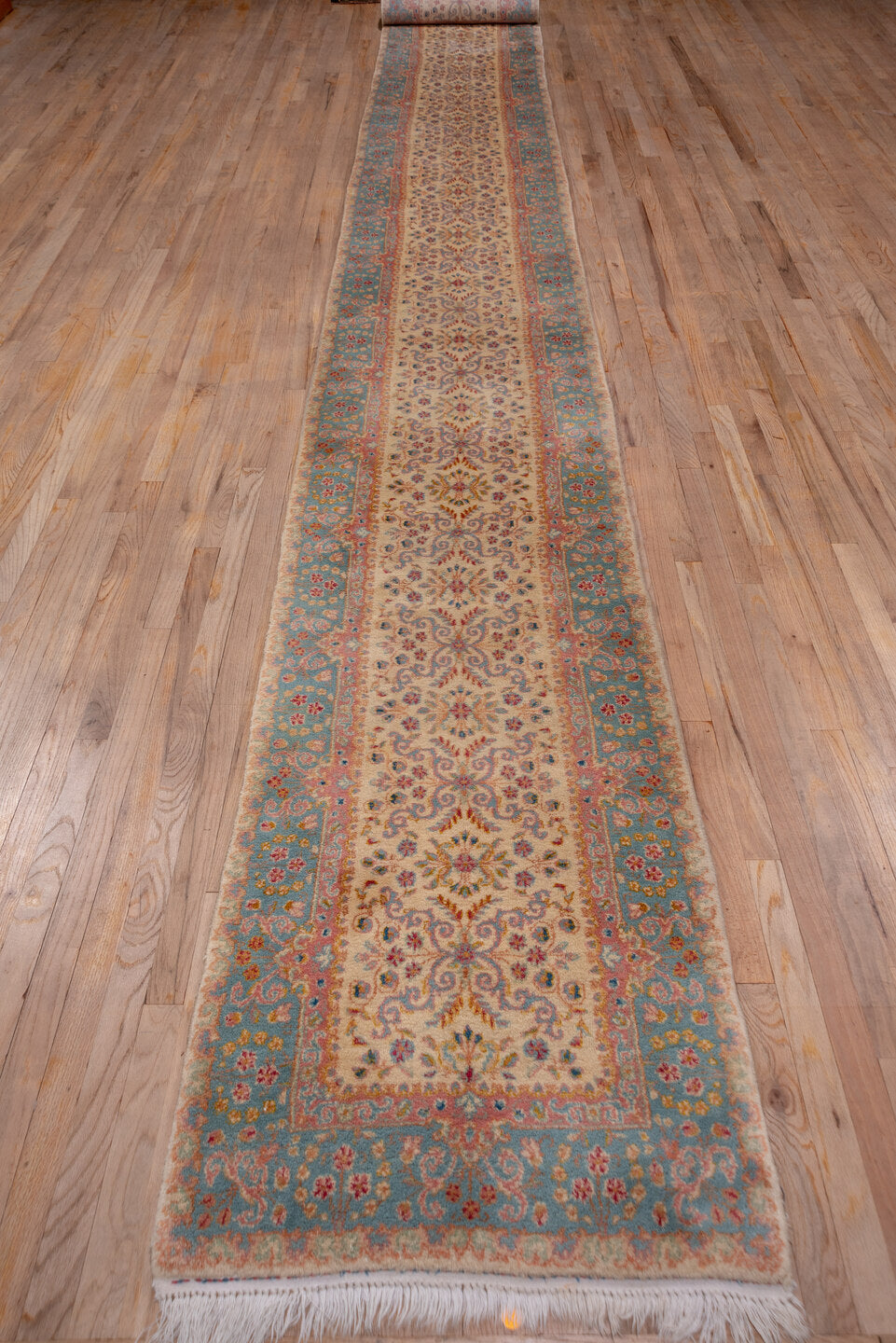 2' x 20' one-of-a-kind handmade vintage Kerman runner rug. Color palette: ivory, blue, rust, rose, gold, taupe, terracotta