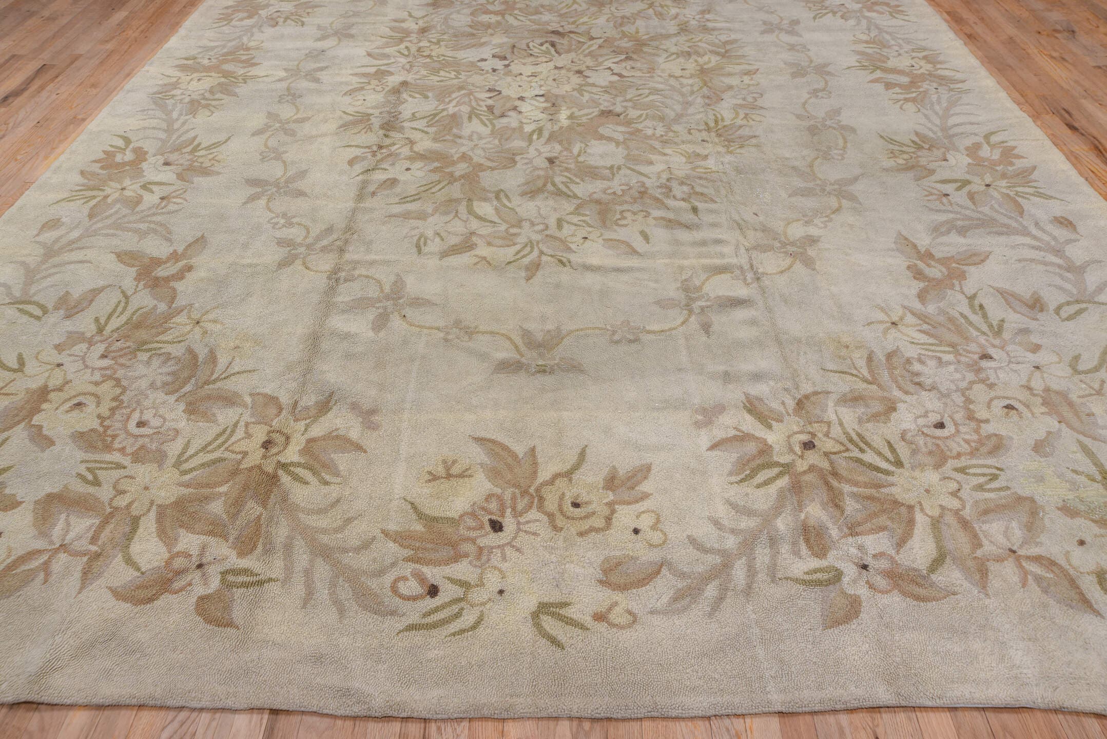 11' x 17' one-of-a-kind handmade antique Hooked oversize rug. Color palette: ivory, beige, taupe, cream, sand, gray