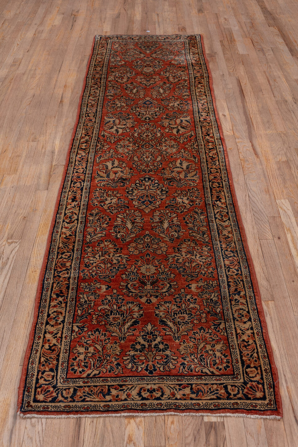 2' x 10' one-of-a-kind handmade antique Sarouk runner rug. Color palette: rust, navy, ivory, blue, camel, brown, terracotta
