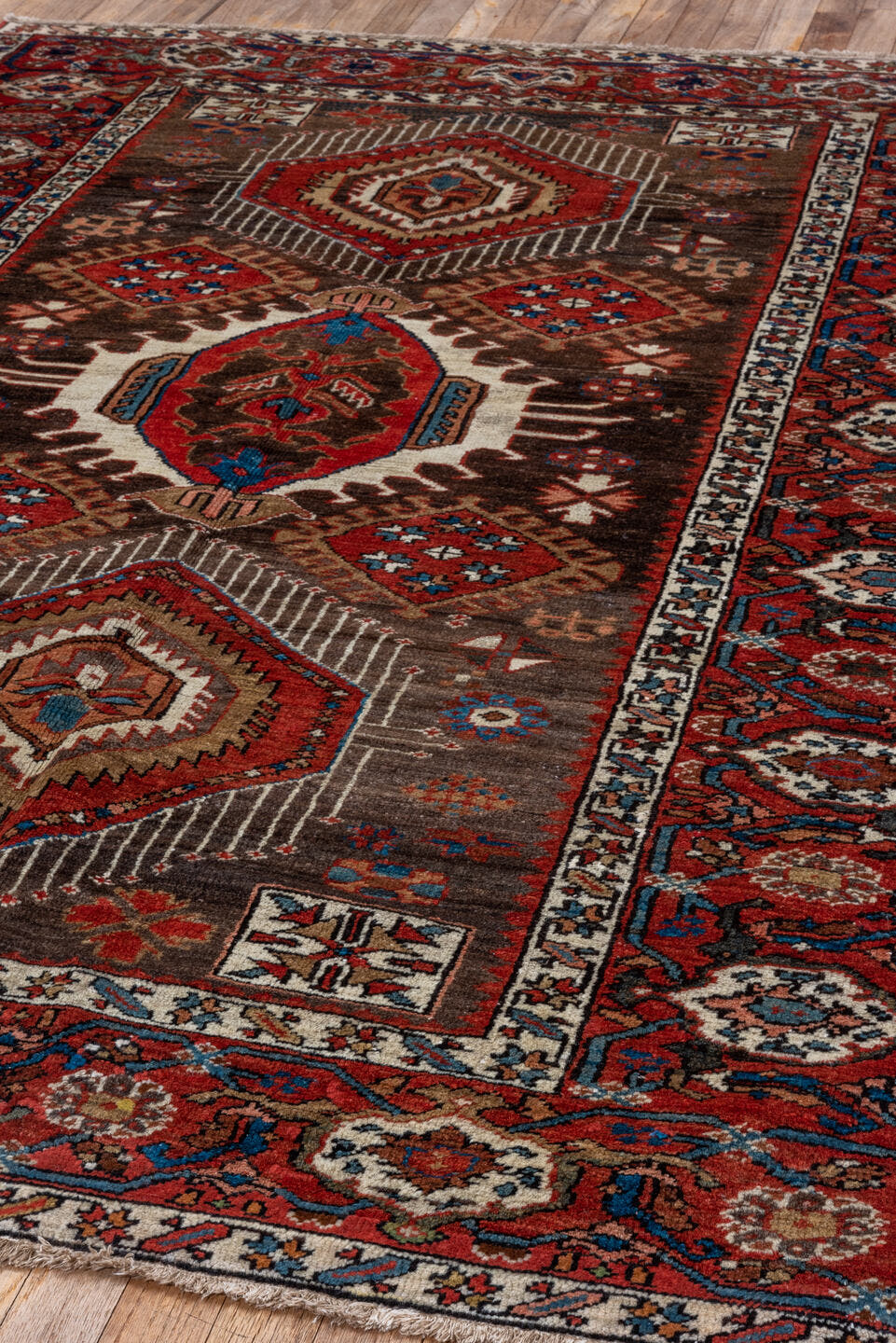 5' x 6' one-of-a-kind handmade antique Karaje rug. Color palette: rust, brown, ivory, indigo, navy, camel, crimson, taupe