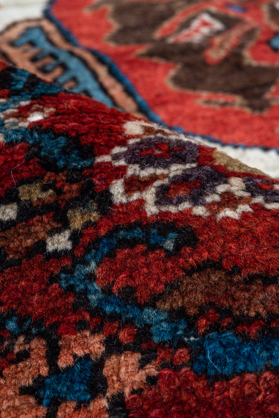 5' x 6' one-of-a-kind handmade antique Karaje rug. Color palette: rust, brown, ivory, indigo, navy, camel, crimson, taupe