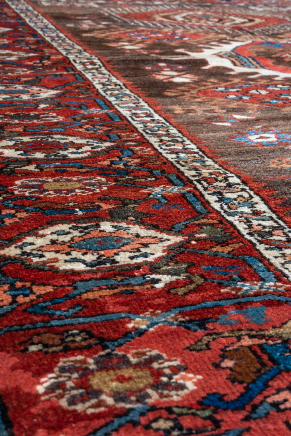 5' x 6' one-of-a-kind handmade antique Karaje rug. Color palette: rust, brown, ivory, indigo, navy, camel, crimson, taupe