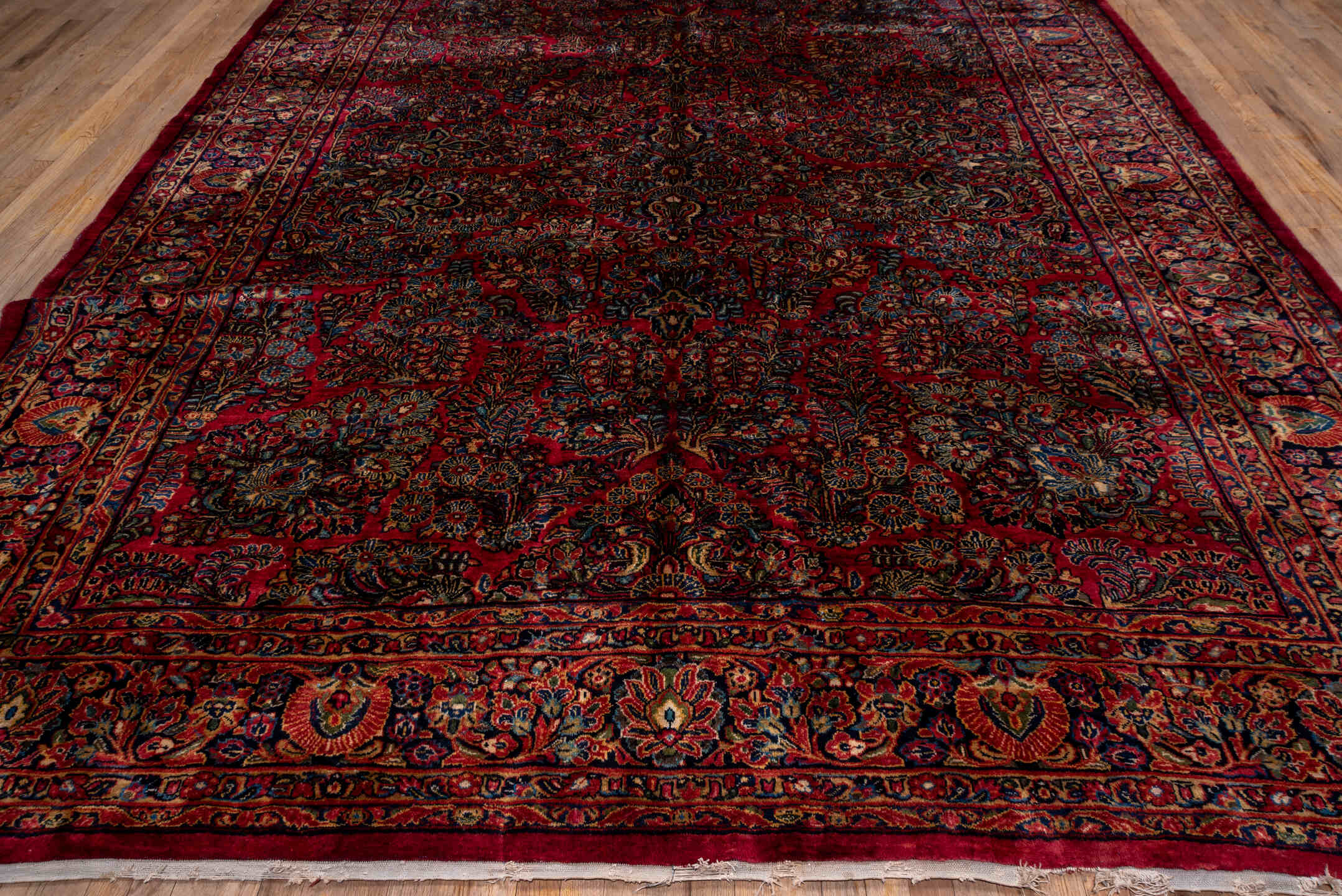 10' x 22' one-of-a-kind handmade vintage Sarouk rug. Color palette: black, blue, brown, burgundy, gray, pink, red