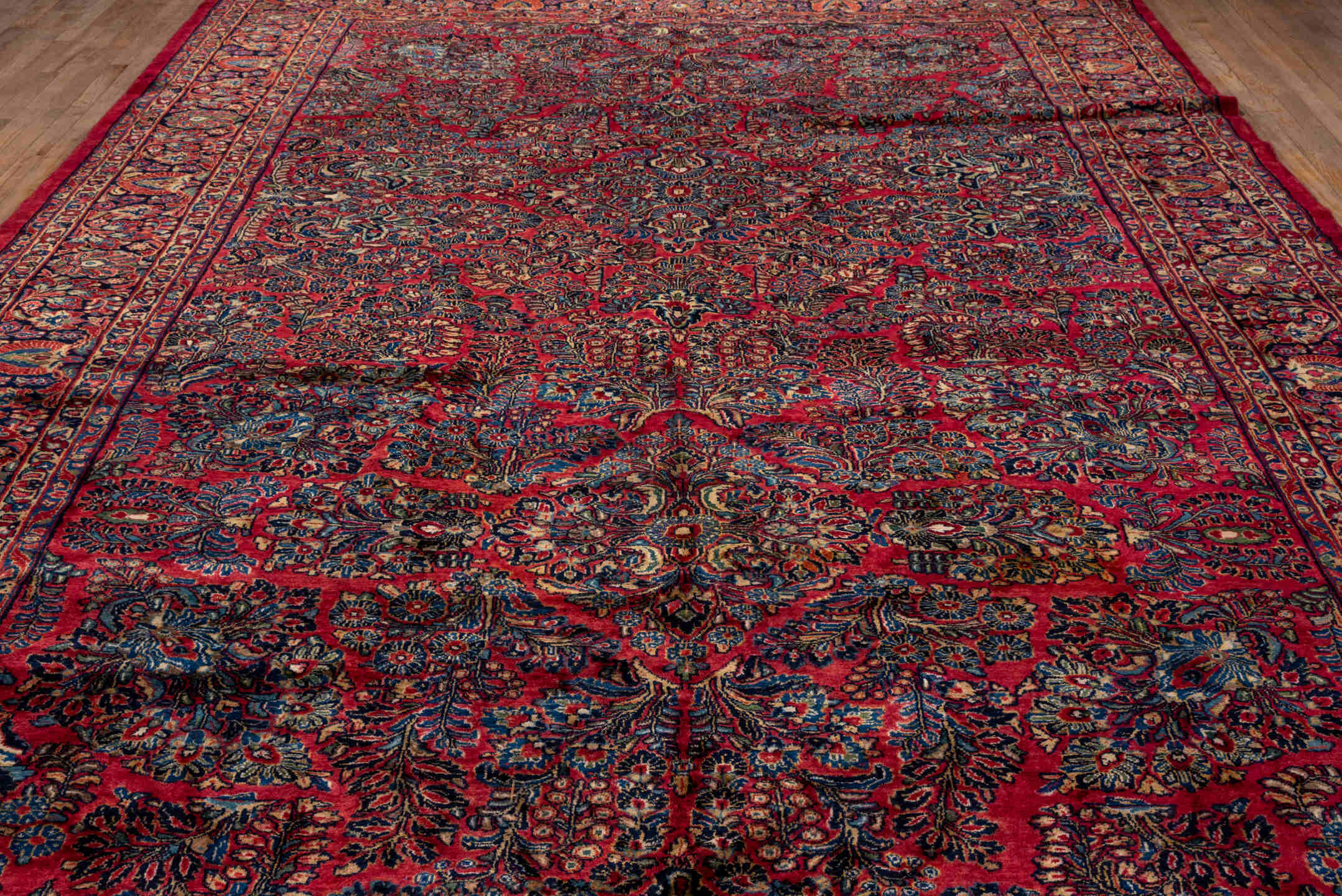 10' x 22' one-of-a-kind handmade vintage Sarouk rug. Color palette: black, blue, brown, burgundy, gray, pink, red