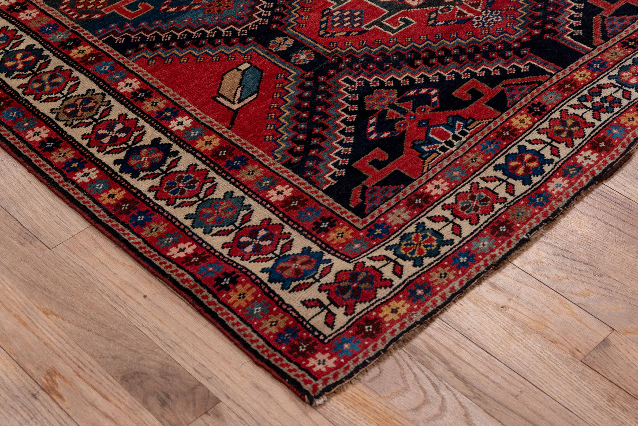 4' x 9' one-of-a-kind handmade antique Baktiary runner rug. Color palette: crimson, navy, ivory, camel, sky blue, rose