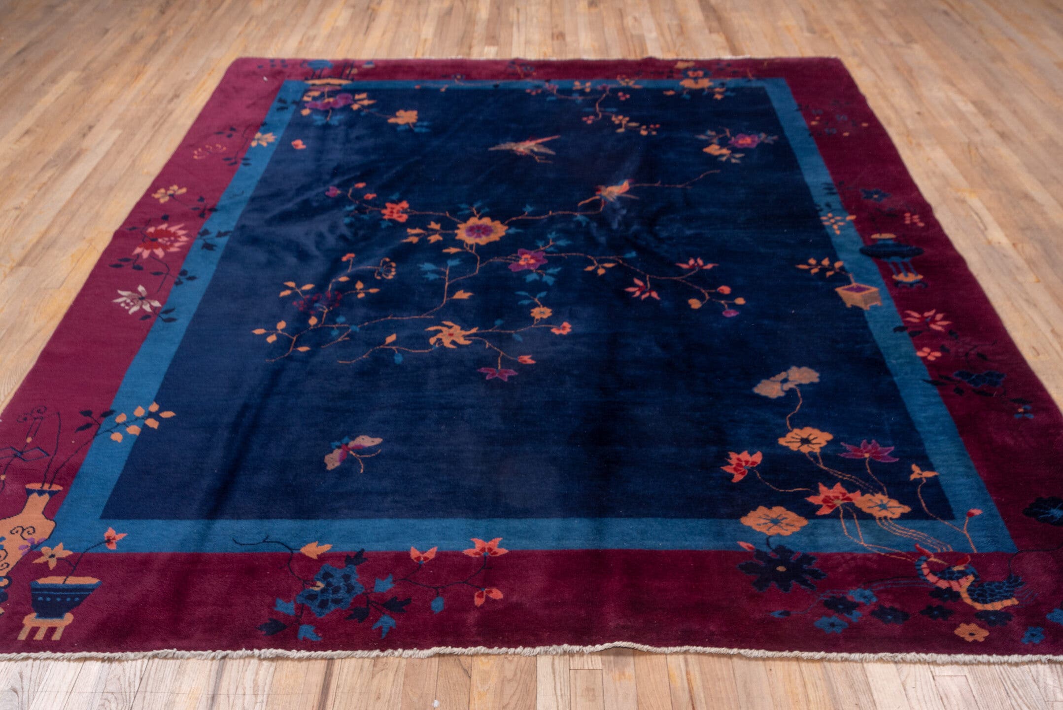 8' x 9' one-of-a-kind handmade antique Chinese rug. Color palette: navy, plum, sky_blue, peach, rose, indigo, ivory, blue