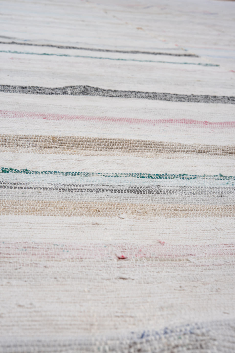 5' x 11' one-of-a-kind handmade antique Rag Rug rug. Color palette: ivory, pale blue, blush, taupe, charcoal, aqua