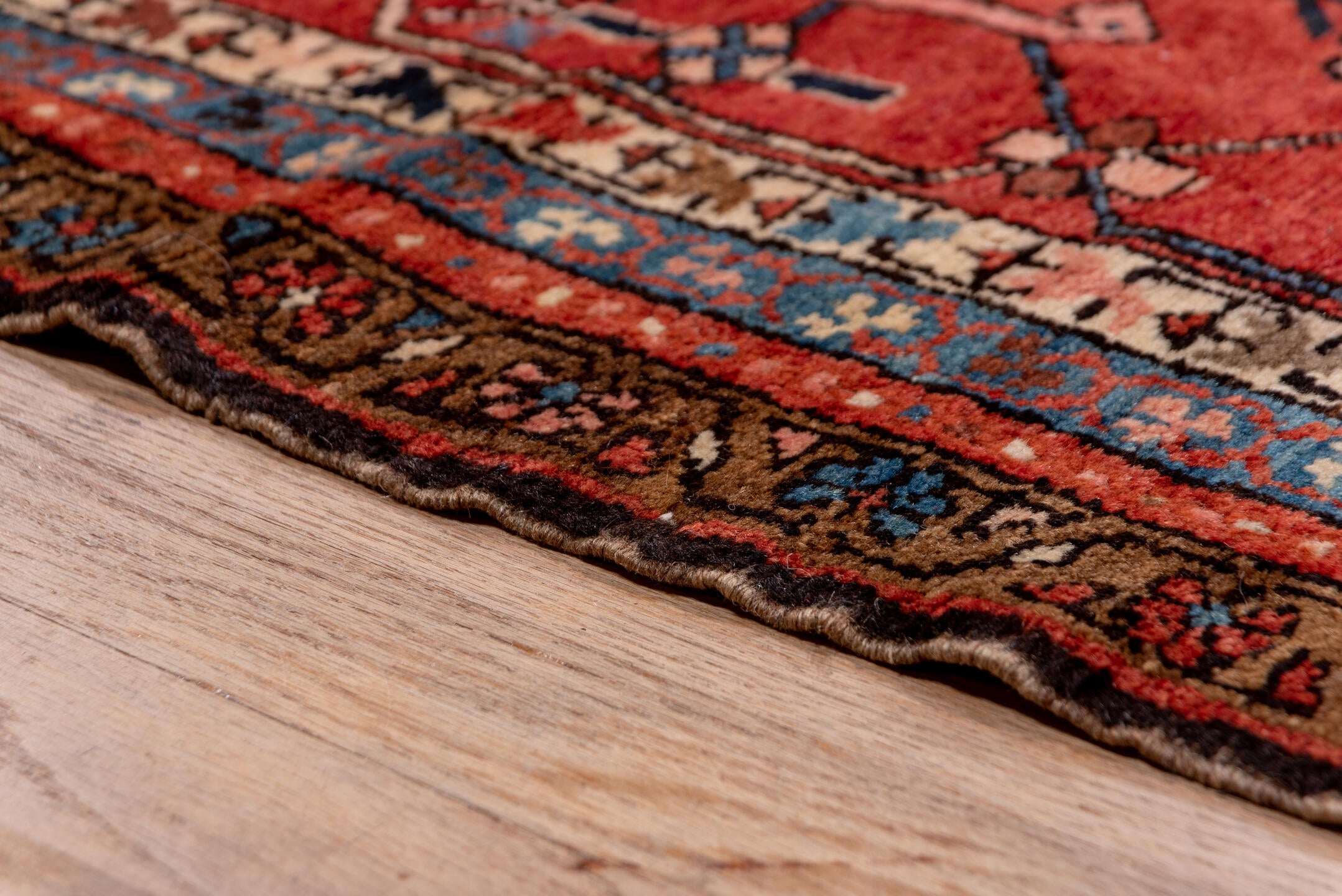 12' x 18' one-of-a-kind handmade antique Serapi oversize rug. Color palette: ivory, rust, brick red, indigo, sky blue, camel