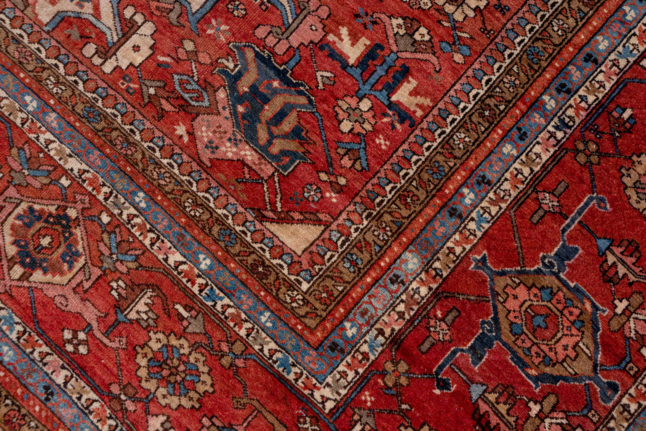 12' x 18' one-of-a-kind handmade antique Serapi oversize rug. Color palette: ivory, rust, brick red, indigo, sky blue, camel