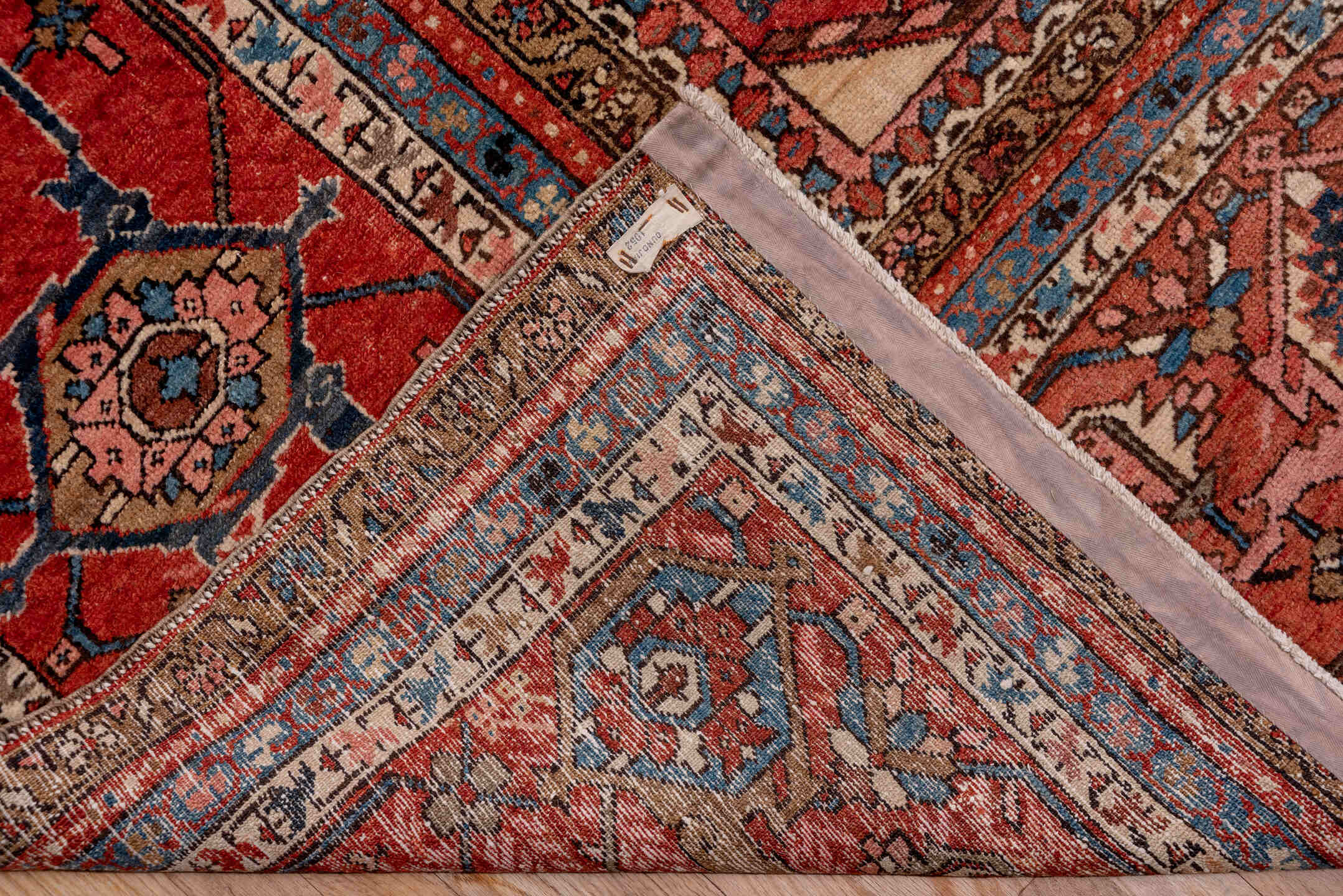 12' x 18' one-of-a-kind handmade antique Serapi oversize rug. Color palette: ivory, rust, brick red, indigo, sky blue, camel