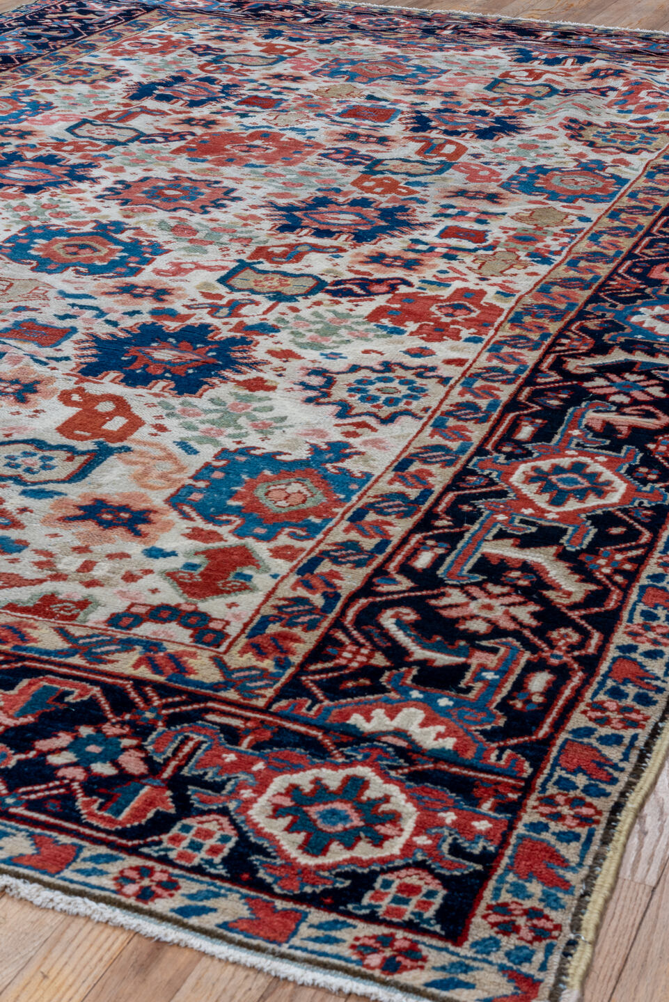 7' x 10' one-of-a-kind handmade antique Heriz large size rug. Color palette: ivory, navy, sky blue, rust, blush, crimson