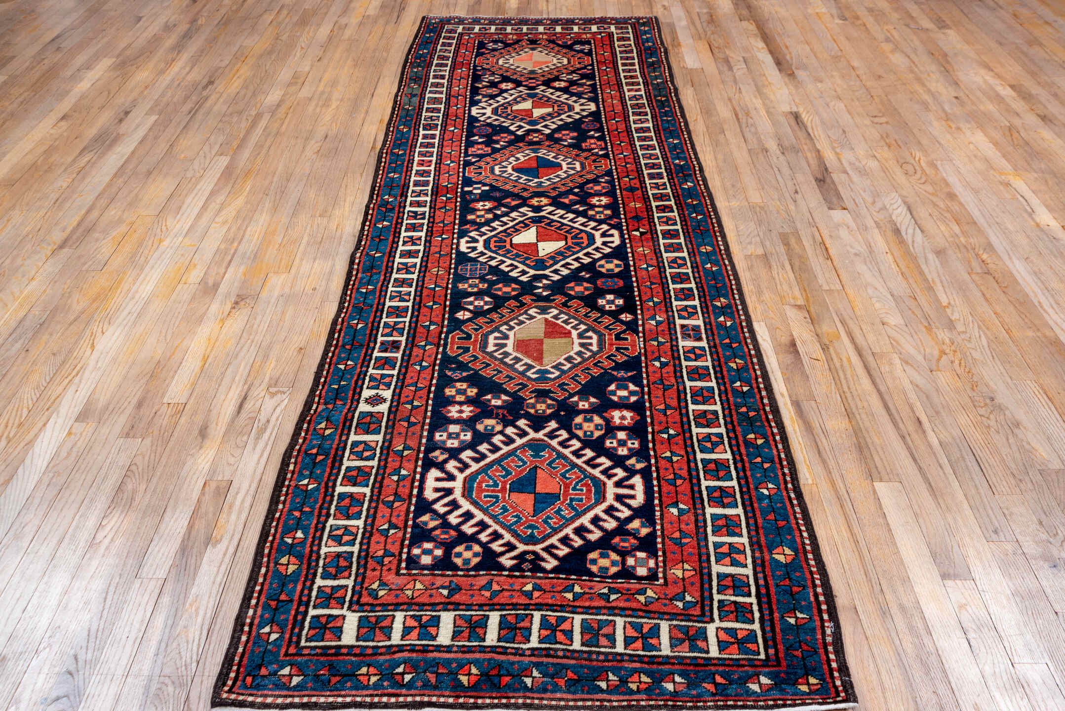 3' x 11' one-of-a-kind handmade antique NW Persian runner rug. Color palette: navy, ivory, rust, indigo, rose, sky_blue