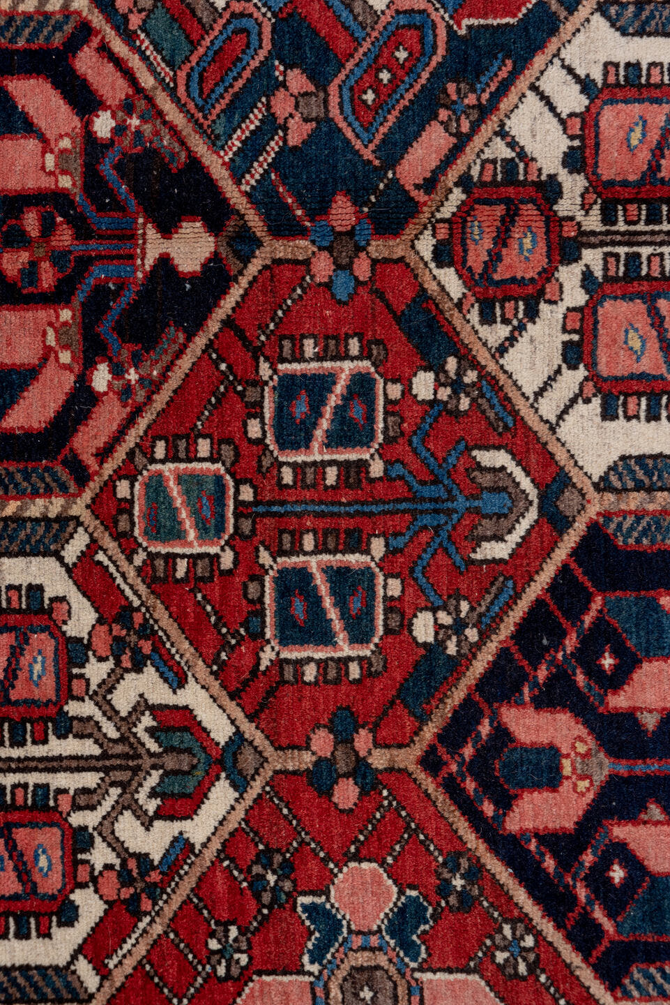 5' x 7' one-of-a-kind handmade antique Baktiary rug. Color palette: rust, ivory, navy, sky_blue, rose, charcoal, slate