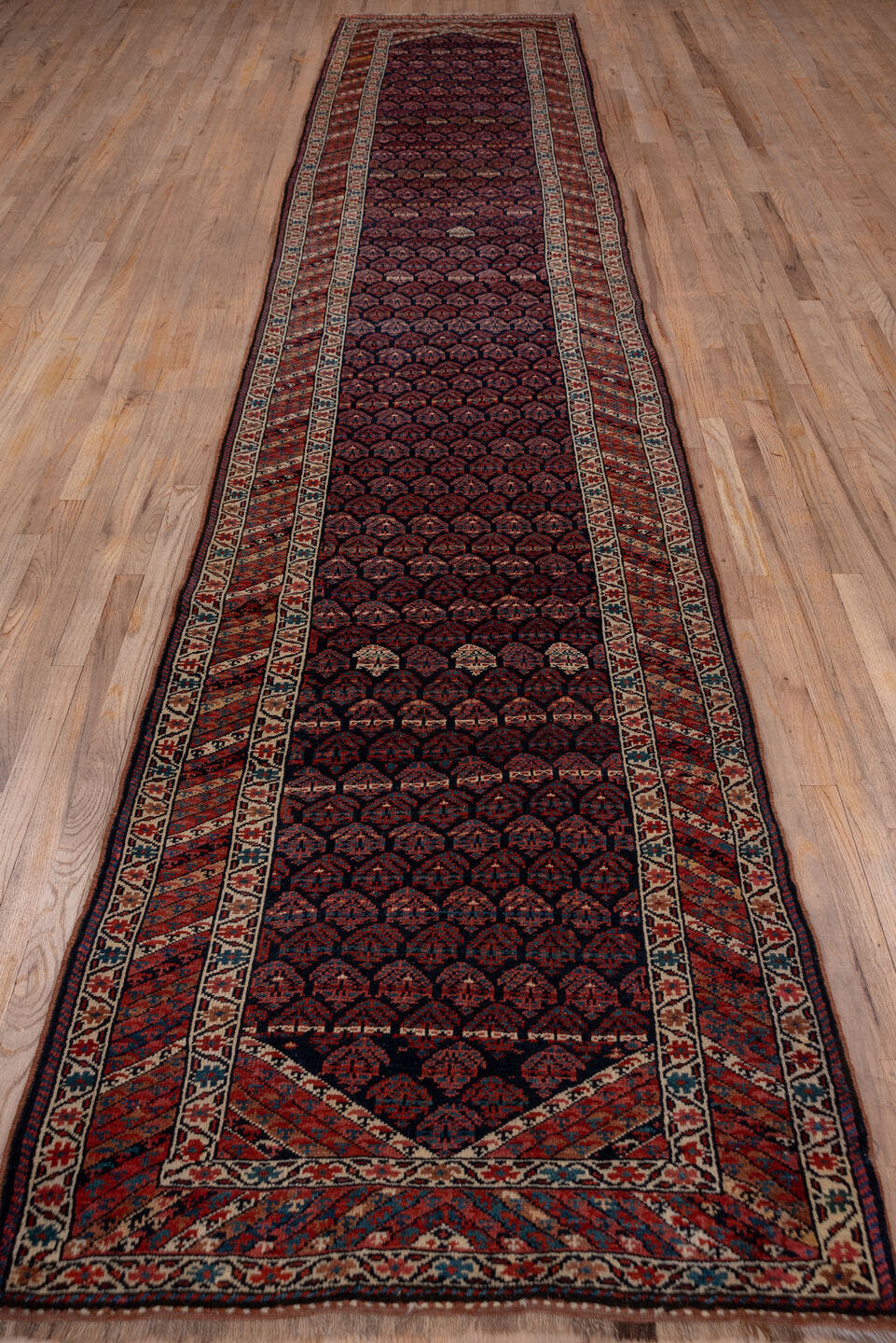 3' x 16' one-of-a-kind handmade antique Kurd runner rug. Color palette: navy, rust, ivory, brick, slate, camel, blue