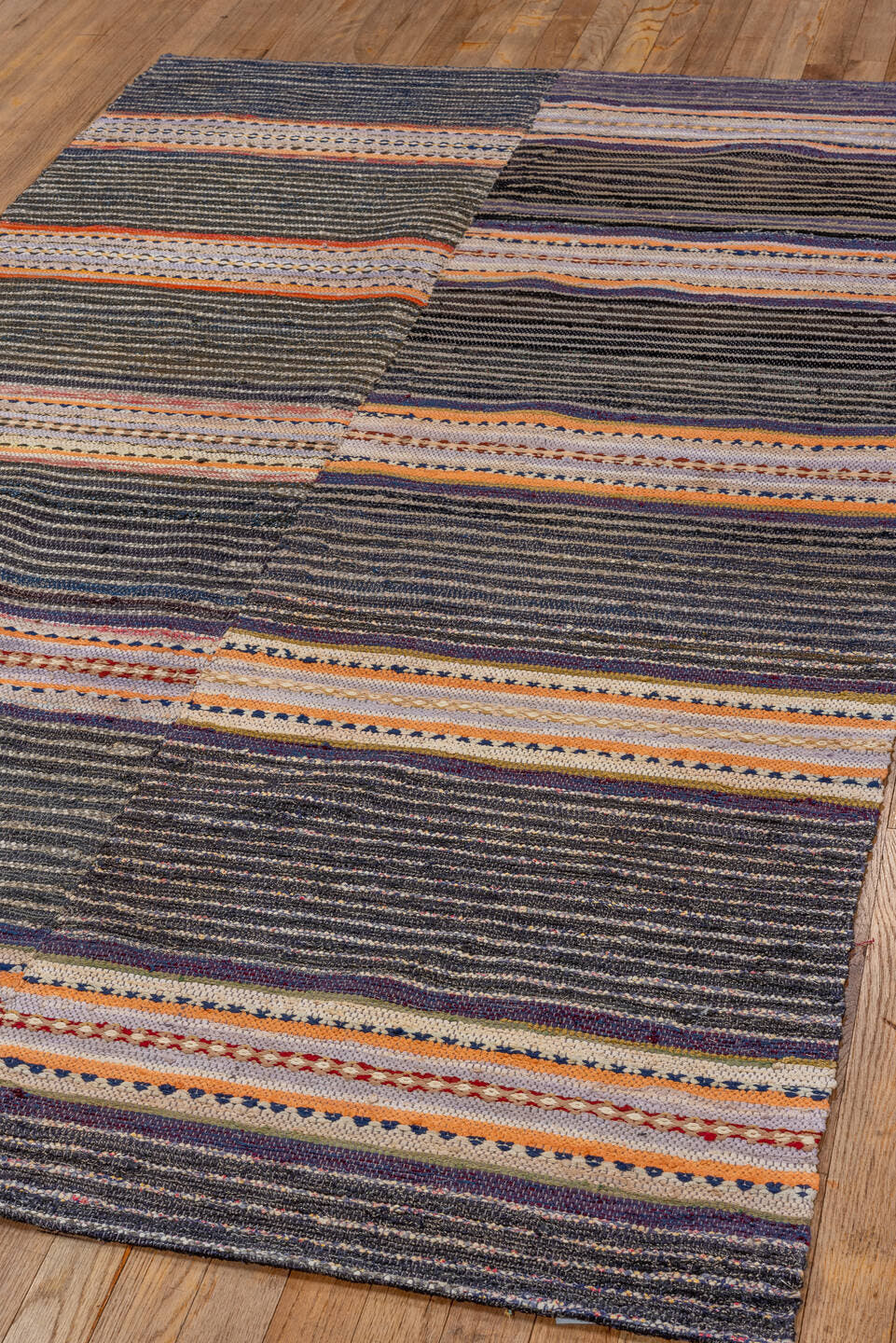 4' x 7' one-of-a-kind handmade antique Rag Rug rug. Color palette: charcoal, ivory, lavender, orange, navy, gray, peach