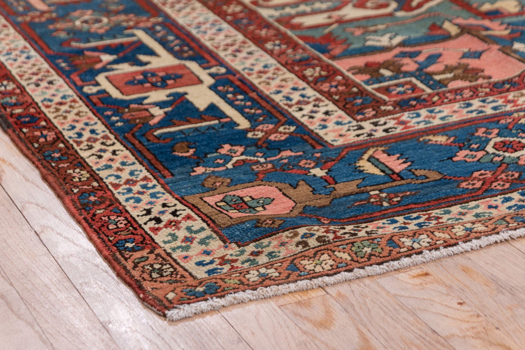 10' x 14' one-of-a-kind handmade antique Serapi large size rug. Color palette: rust, ivory, indigo, sky blue, rose, taupe