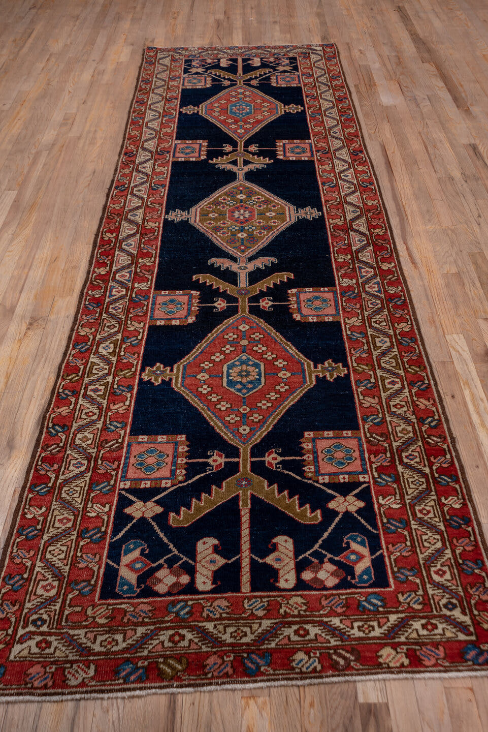 3' x 11' one-of-a-kind handmade antique Serapi runner rug. Color palette: navy, rust, ivory, camel, sky blue, rose, brown