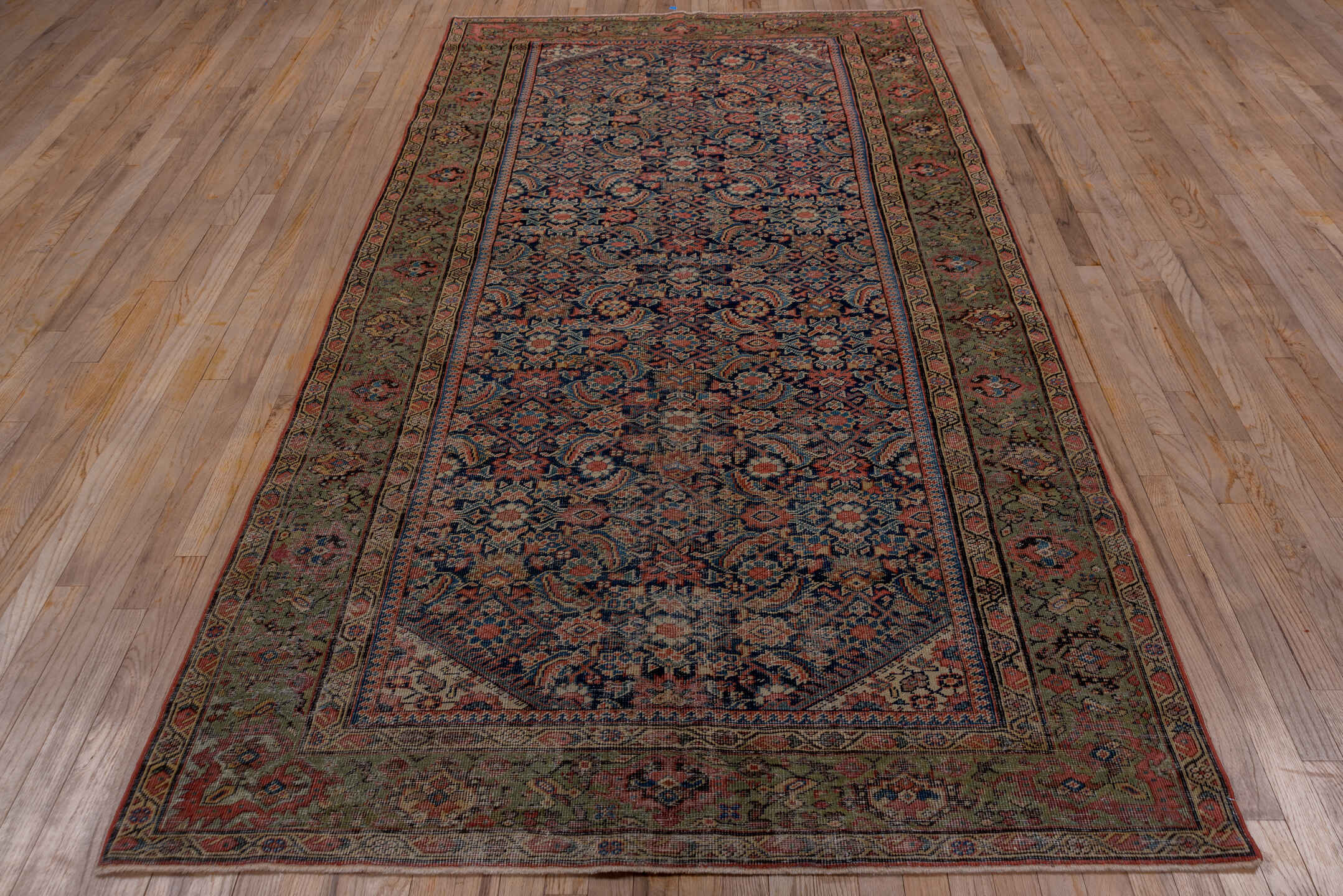 5' x 9' one-of-a-kind handmade vintage Farahan medium size rug. Color palette: black, blue, brown, gray, pink, red, redwood