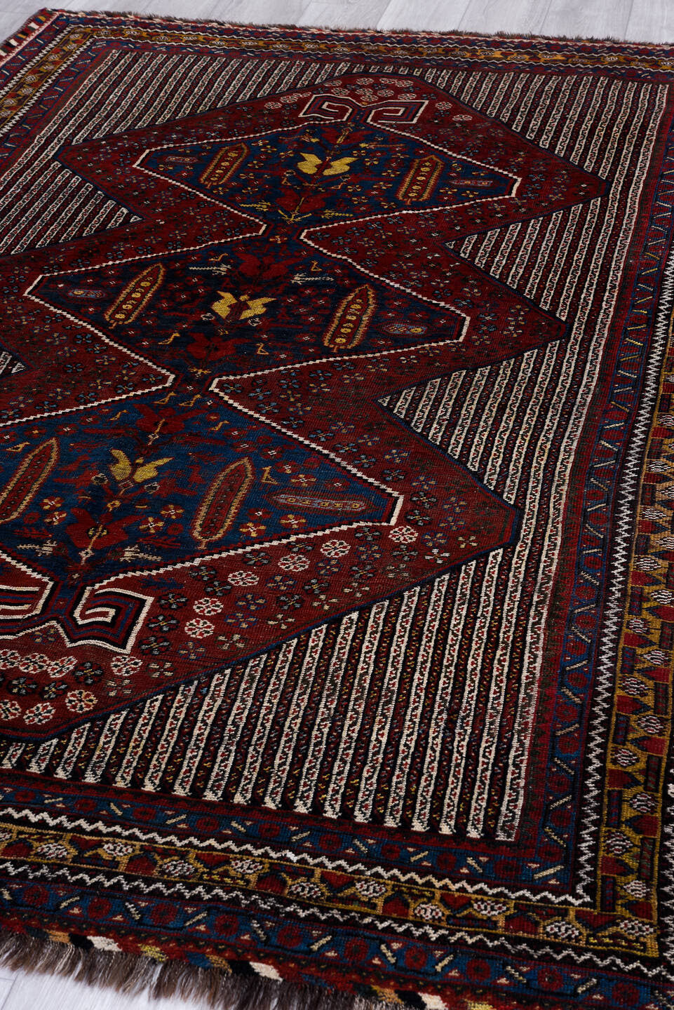 5' x 8' one-of-a-kind handmade antique Qashqai medium size rug. Color palette: rust, indigo, ivory, gold, navy, brown