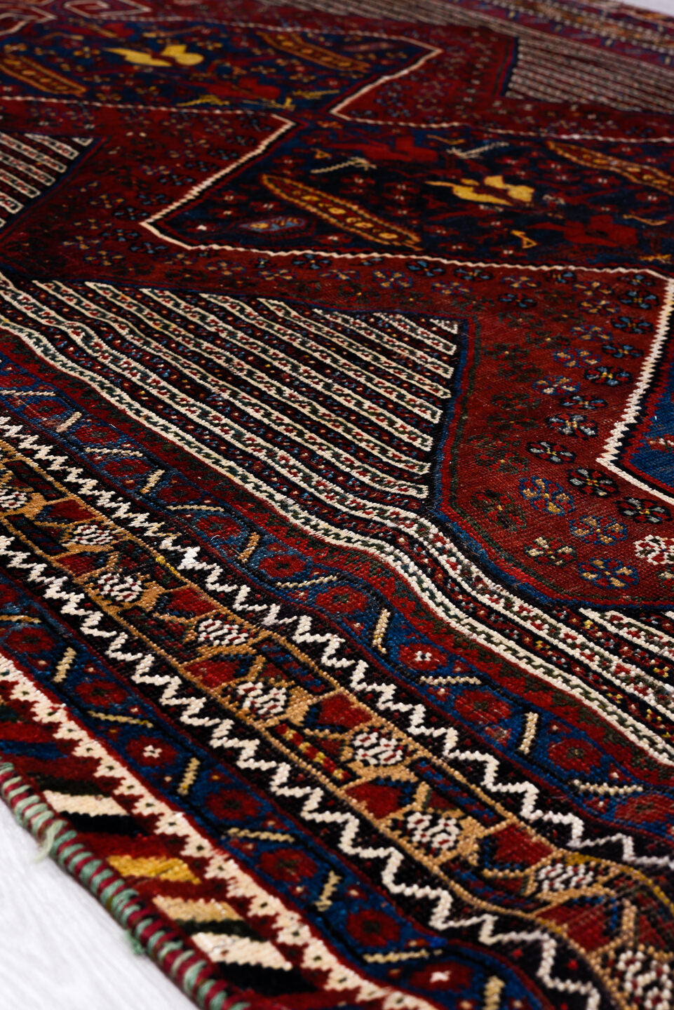 5' x 8' one-of-a-kind handmade vintage Qashqai medium size rug. Color palette: blue, brown, gray, light gray, off-white