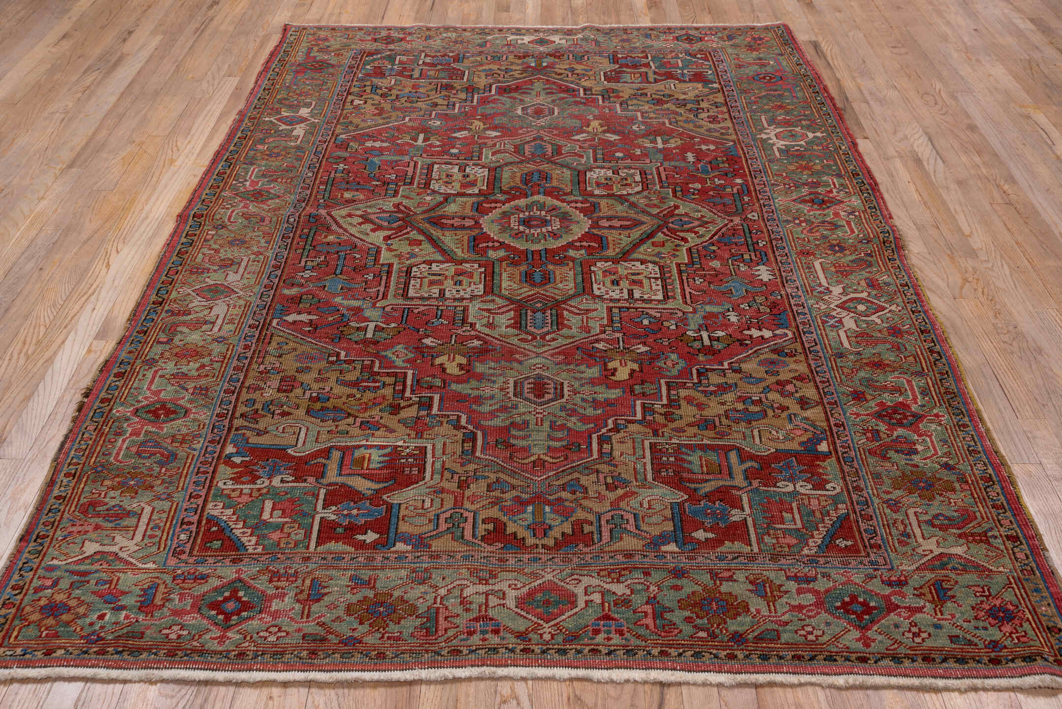 6' x 8' one-of-a-kind handmade antique Heriz medium size rug. Color palette: rust, sage, ivory, navy, rose, taupe, slate
