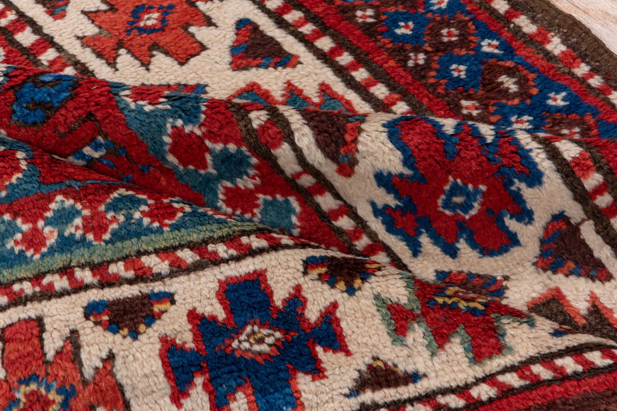 3' x 8' one-of-a-kind handmade vintage Kazak runner rug. Color palette: red, ivory, blue, rust, navy, turquoise, brown