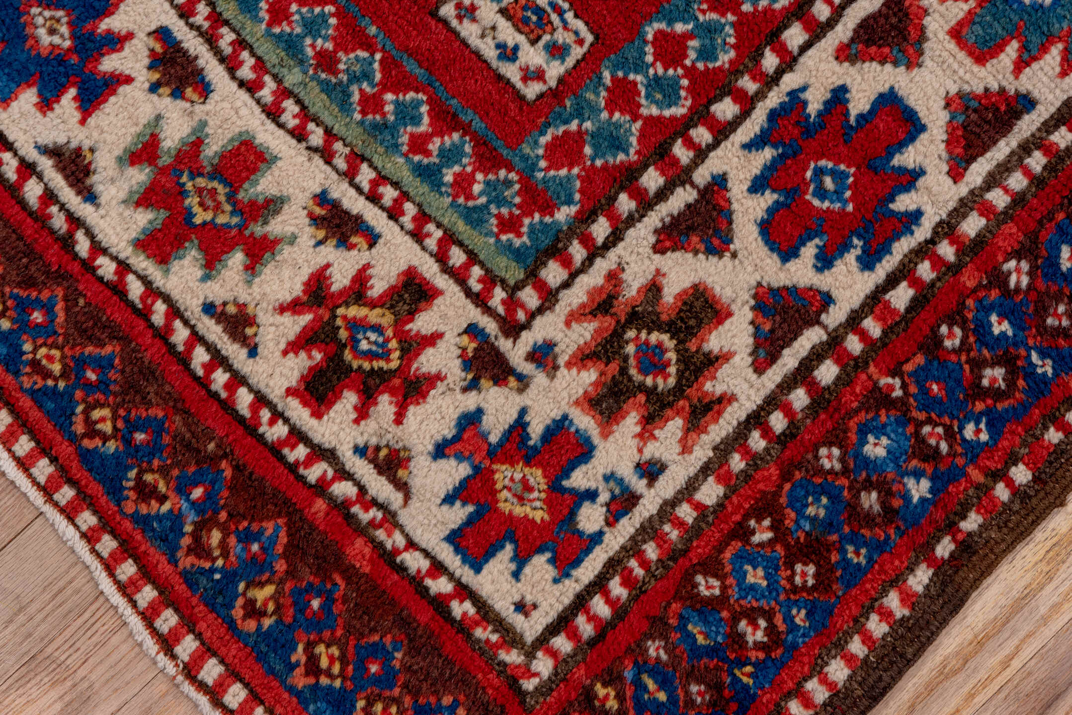3' x 8' one-of-a-kind handmade vintage Kazak runner rug. Color palette: red, ivory, blue, rust, navy, turquoise, brown