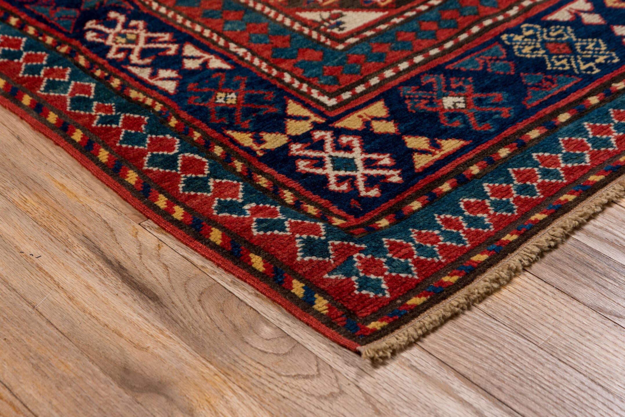 3' x 7' one-of-a-kind handmade vintage Kazak rug. Color palette: ivory, navy, teal, rust, crimson, gold, blue, terracotta
