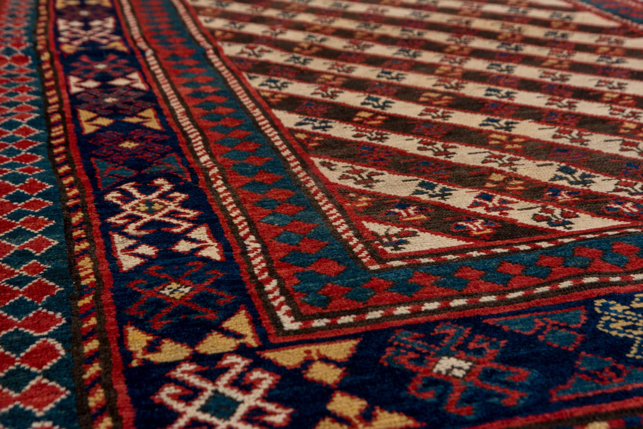 3' x 7' one-of-a-kind handmade vintage Kazak rug. Color palette: ivory, navy, teal, rust, crimson, gold, blue, terracotta