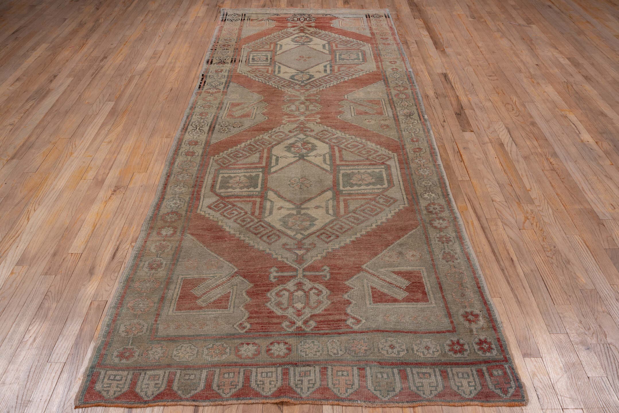 4' x 11' one-of-a-kind handmade vintage Oushak runner rug. Color palette: terra cotta, taupe, sage, ivory, rose, charcoal