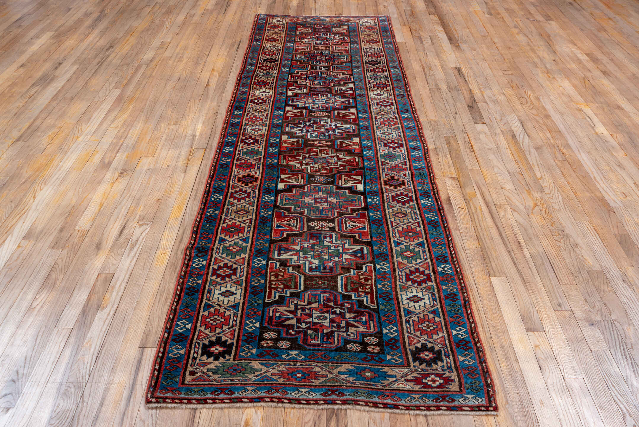 3' x 10' one-of-a-kind handmade vintage Kurd runner rug. Color palette: black, blue, brown, gray, pink, red