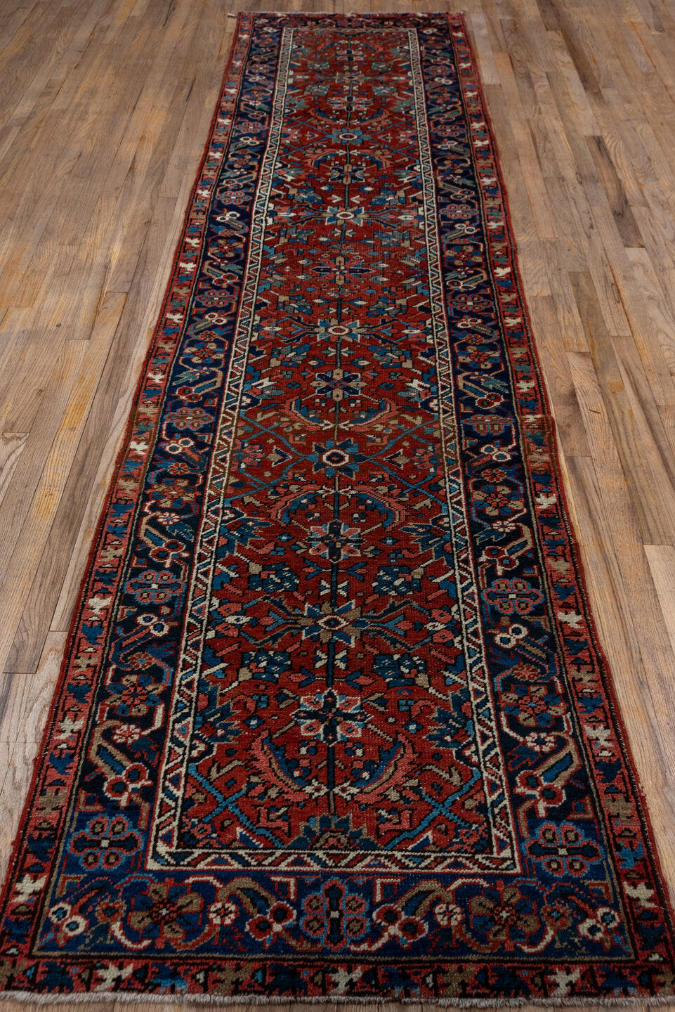 3' x 12' one-of-a-kind handmade vintage Heriz runner rug. Color palette: rust, navy, ivory, sky blue, rose, camel