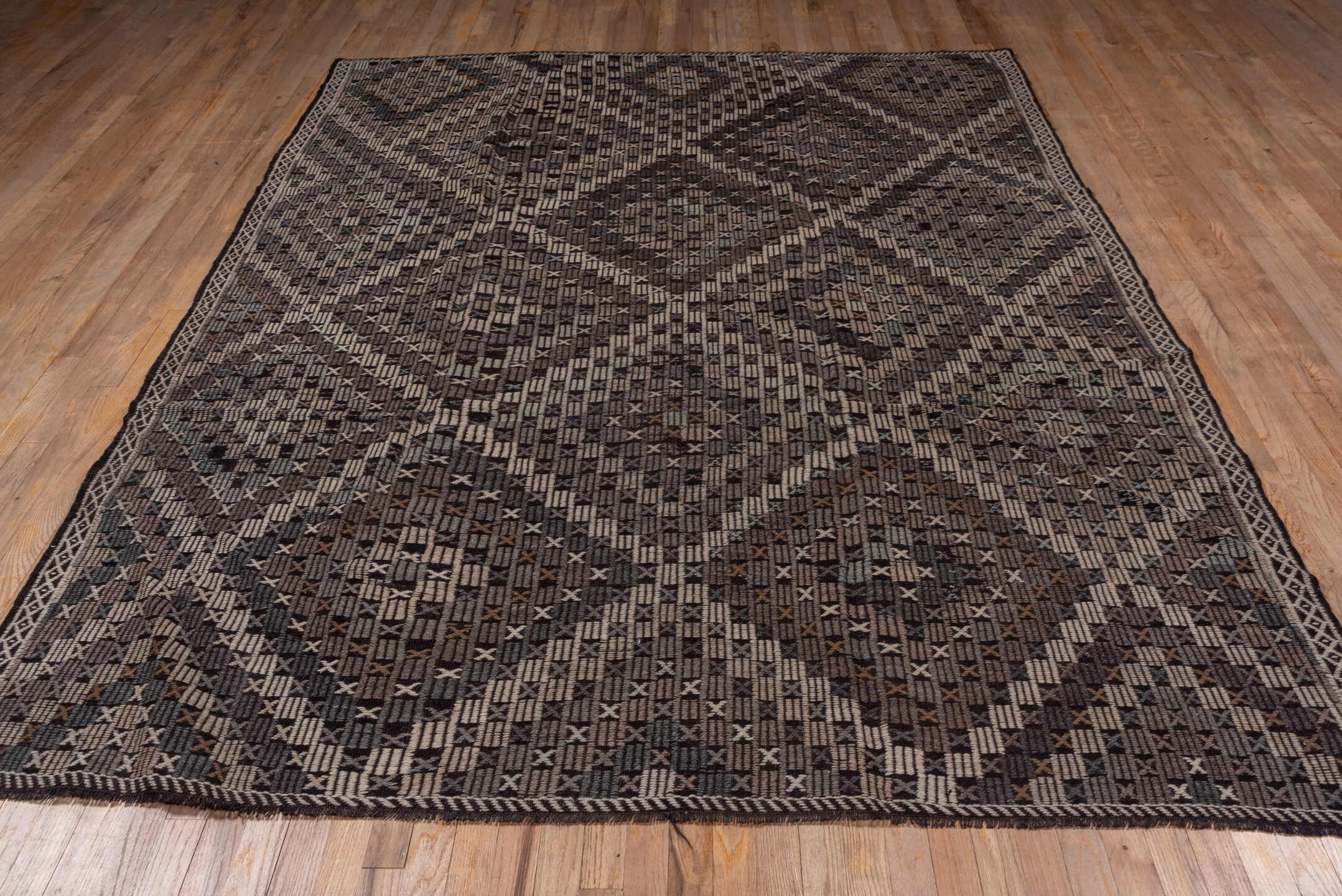 7' x 9' one-of-a-kind handmade vintage Jijim rug. Color palette: black, brown, charcoal, dark gray, dim gray, gray, pink