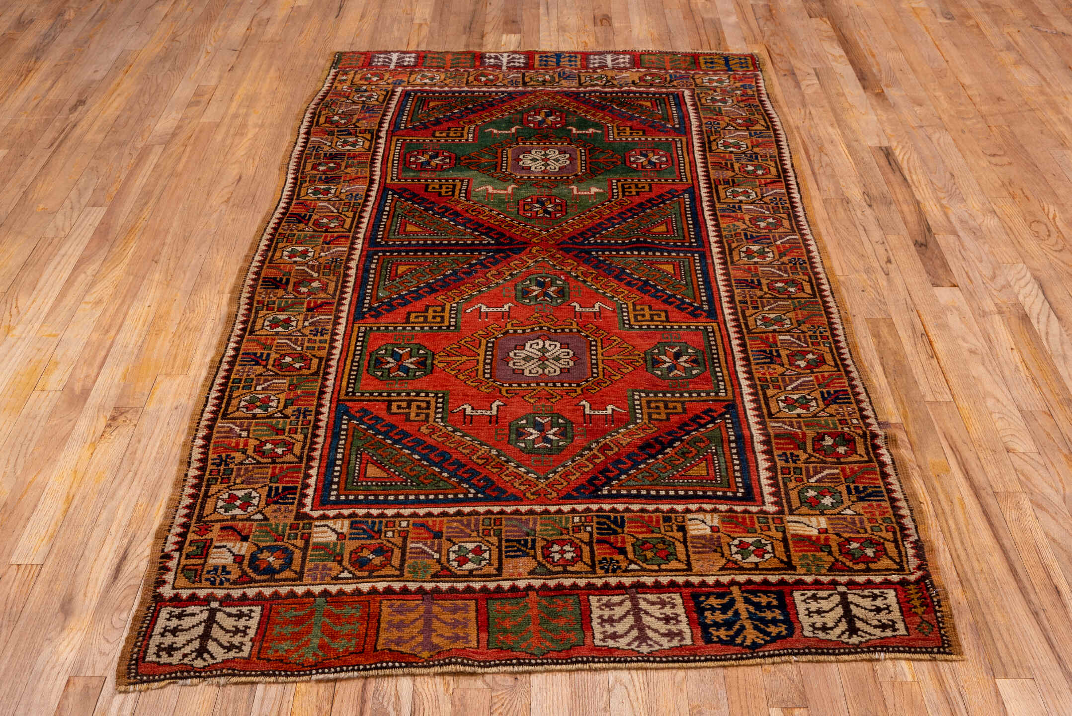 4' x 8' one-of-a-kind handmade antique Konya rug. Color palette: rust, terra cotta, sage, indigo, ivory, camel, burgundy