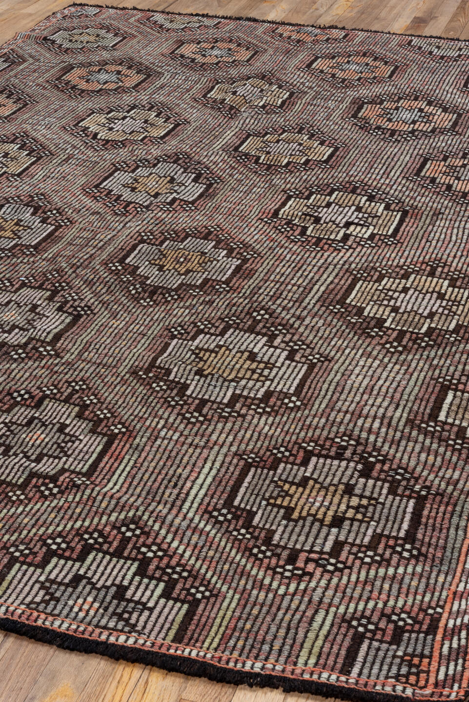 5' x 8' one-of-a-kind handmade vintage Jijim medium size rug. Color palette: black, brown, gray, light gray, off-white, pink