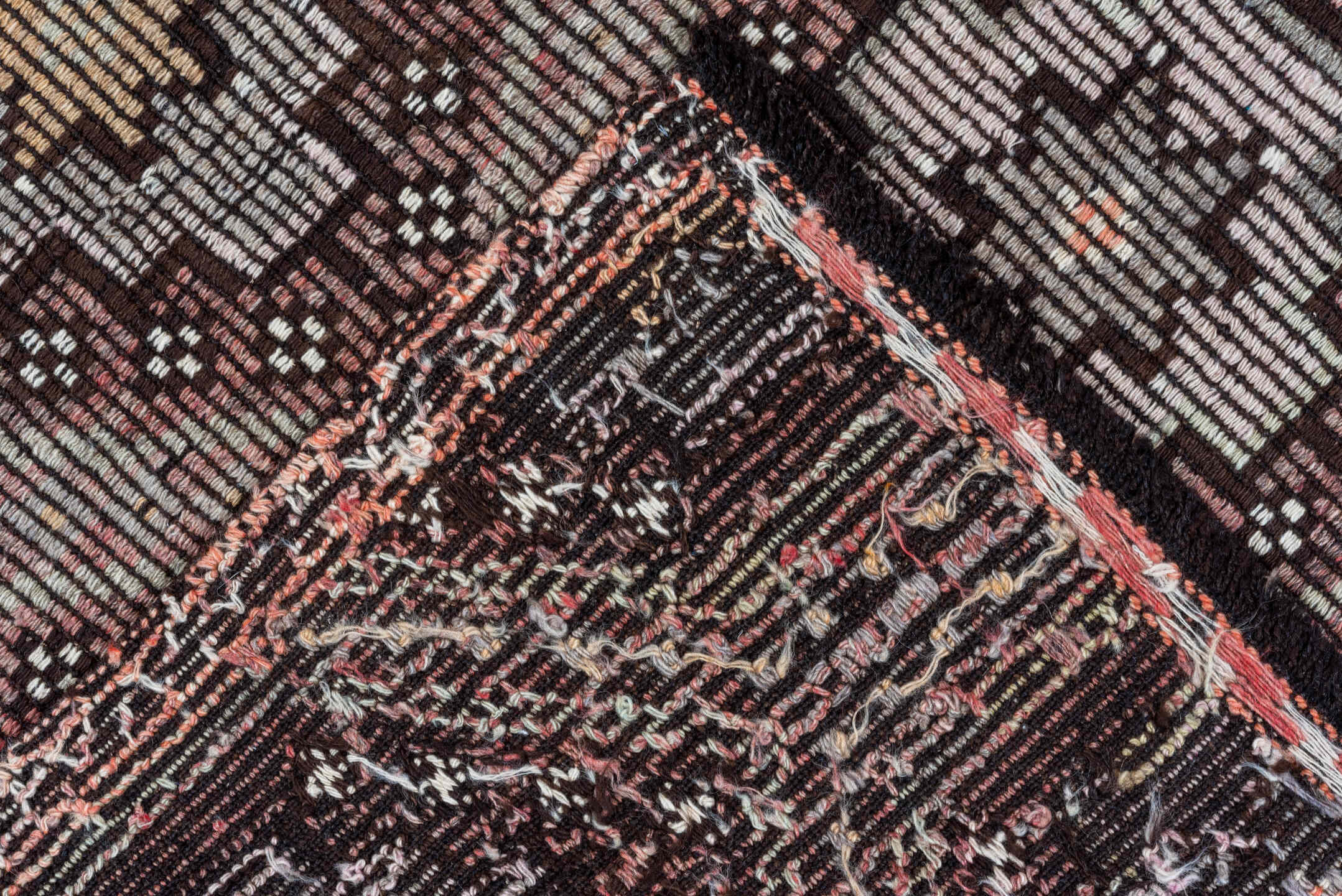 5' x 8' one-of-a-kind handmade vintage Jijim medium size rug. Color palette: black, brown, gray, light gray, off-white, pink