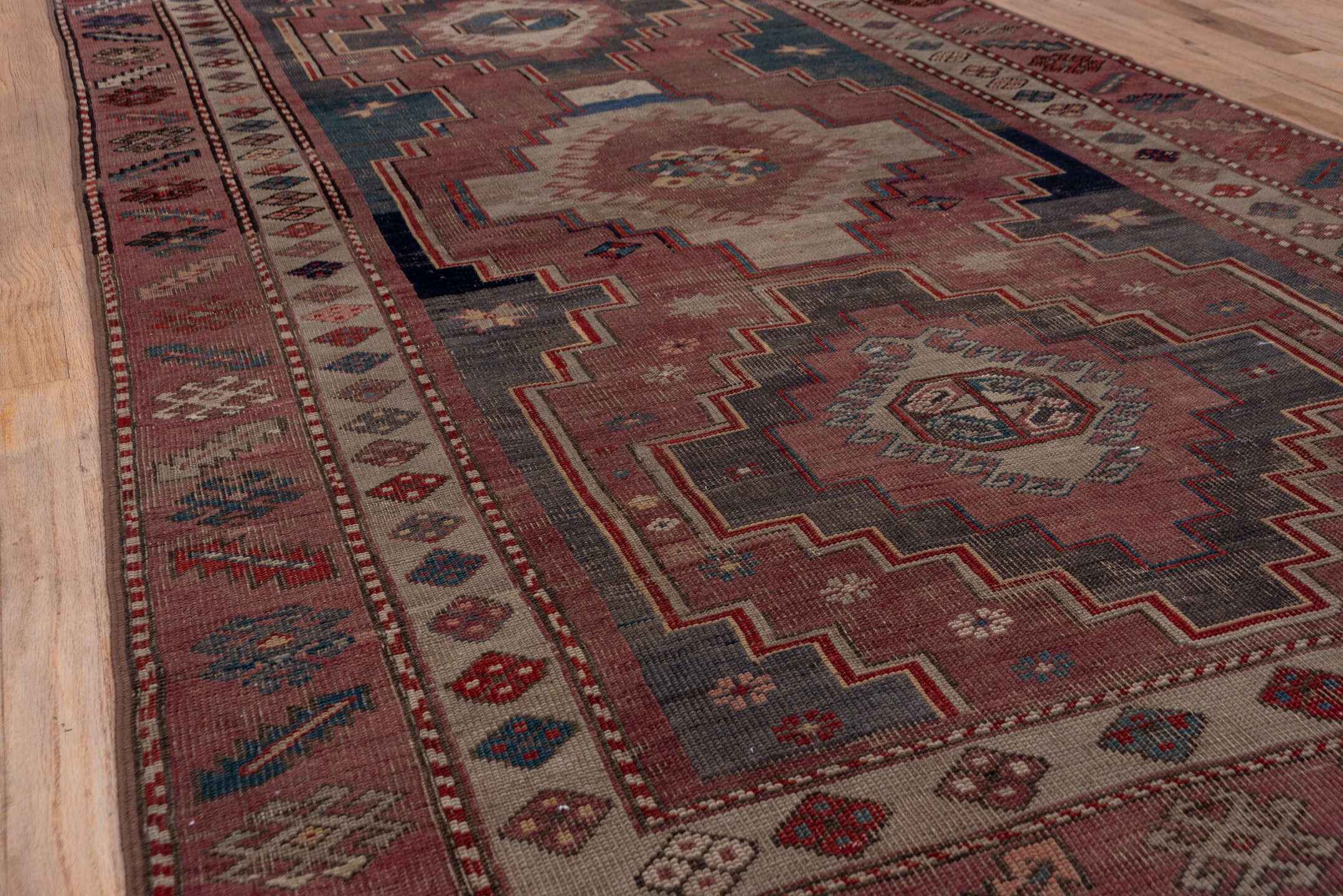 4' x 7' one-of-a-kind handmade antique Trans Caucasian rug. Color palette: rose, dusty rose, ivory, indigo, rust, taupe