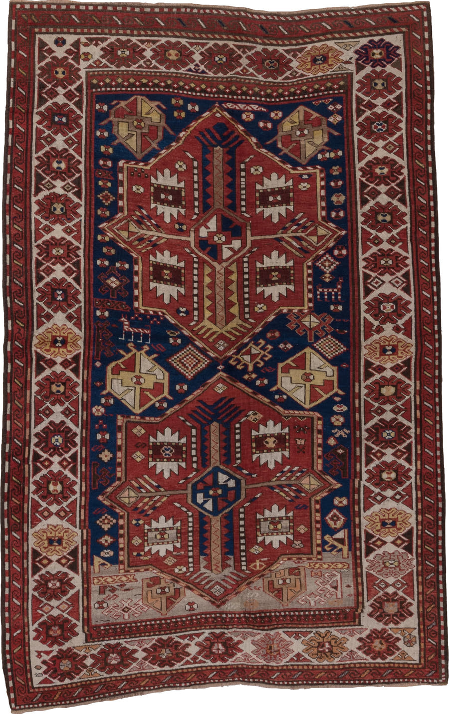 5' x 7' one-of-a-kind handmade antique Trans Caucasian rug. Color palette: rust, ivory, navy, burgundy, camel, crimson, gold