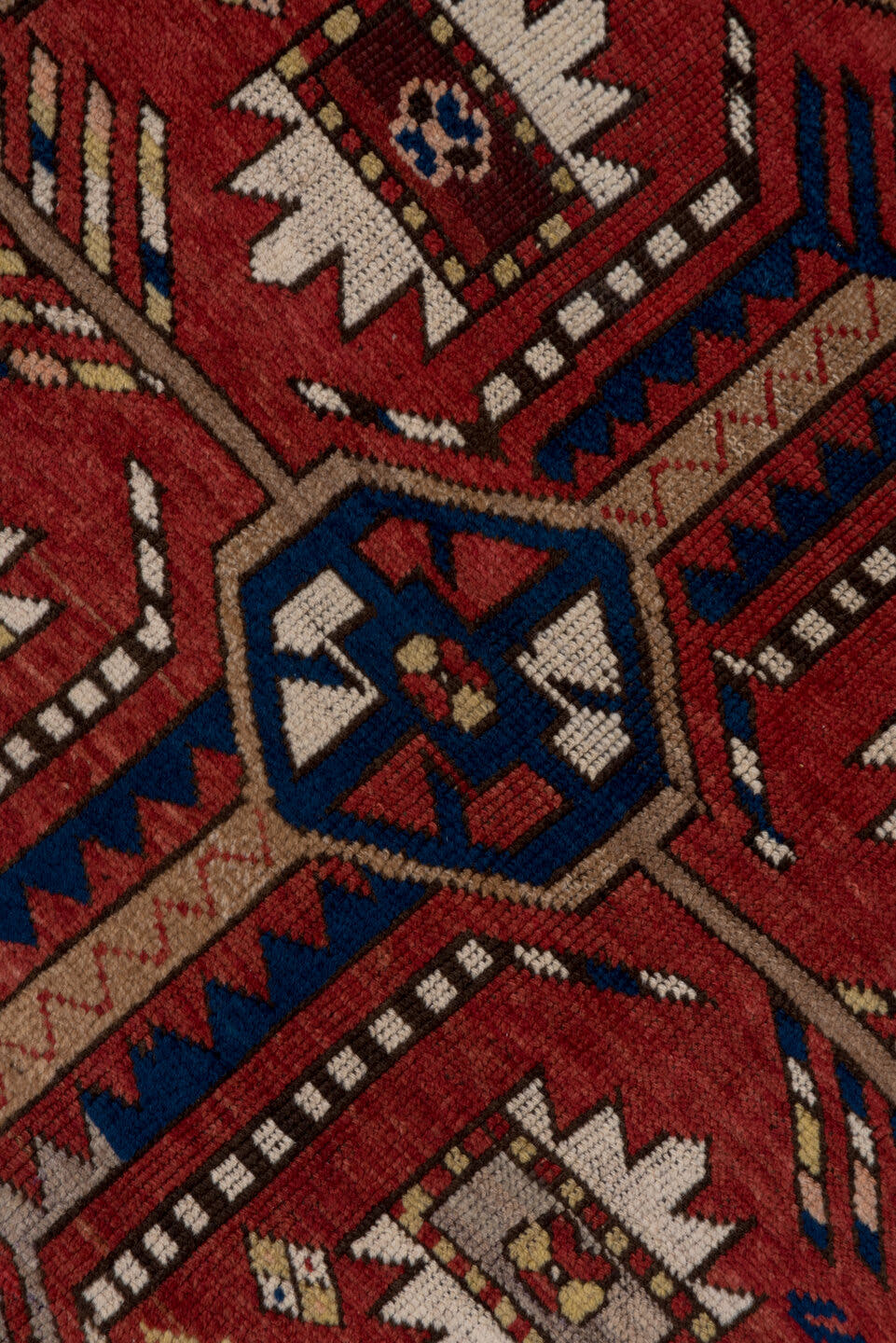 5' x 7' one-of-a-kind handmade antique Trans Caucasian rug. Color palette: rust, ivory, navy, burgundy, camel, crimson, gold