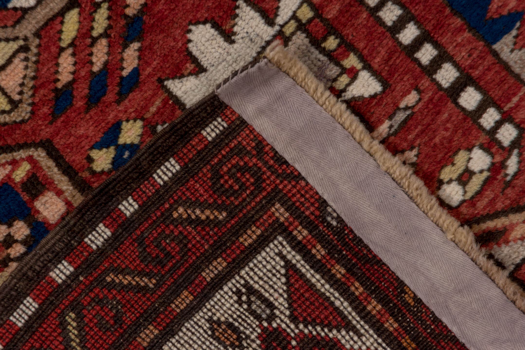 5' x 7' one-of-a-kind handmade antique Trans Caucasian rug. Color palette: rust, ivory, navy, burgundy, camel, crimson, gold