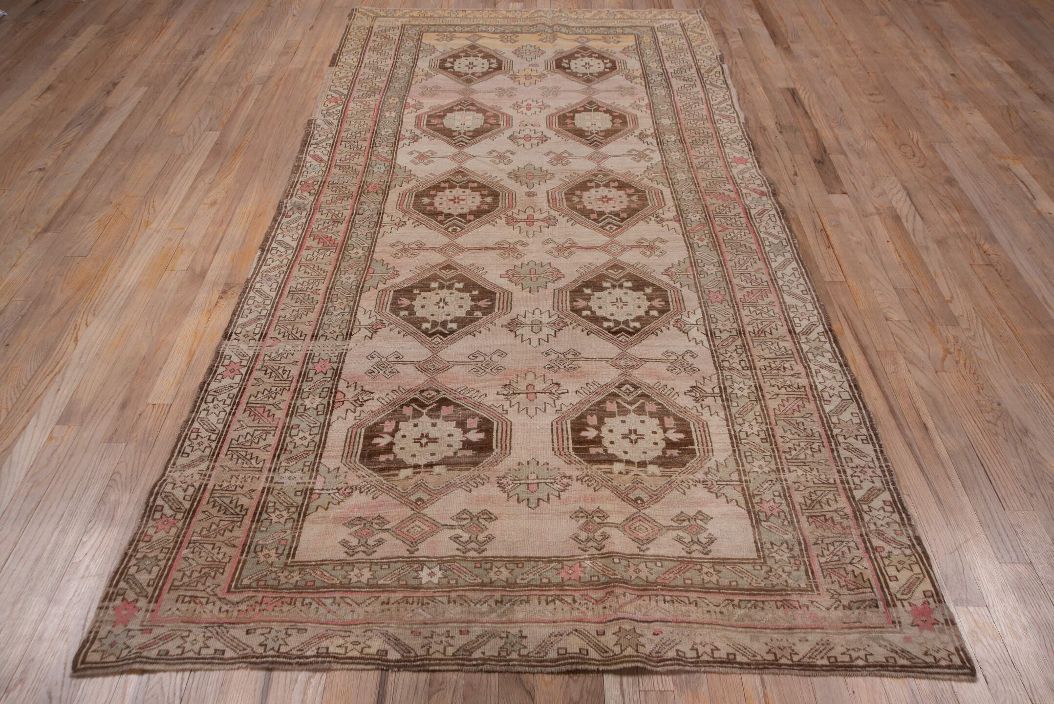 4' x 9' one-of-a-kind handmade antique Trans Caucasian runner rug. Color palette: ivory, taupe, brown, dusty_rose, camel
