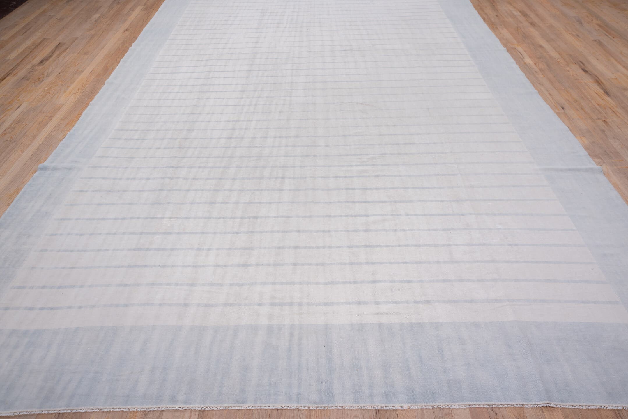 9' x 17' one-of-a-kind handmade antique Dhurrie rug. Color palette: pale blue, ivory, sky blue, light blue