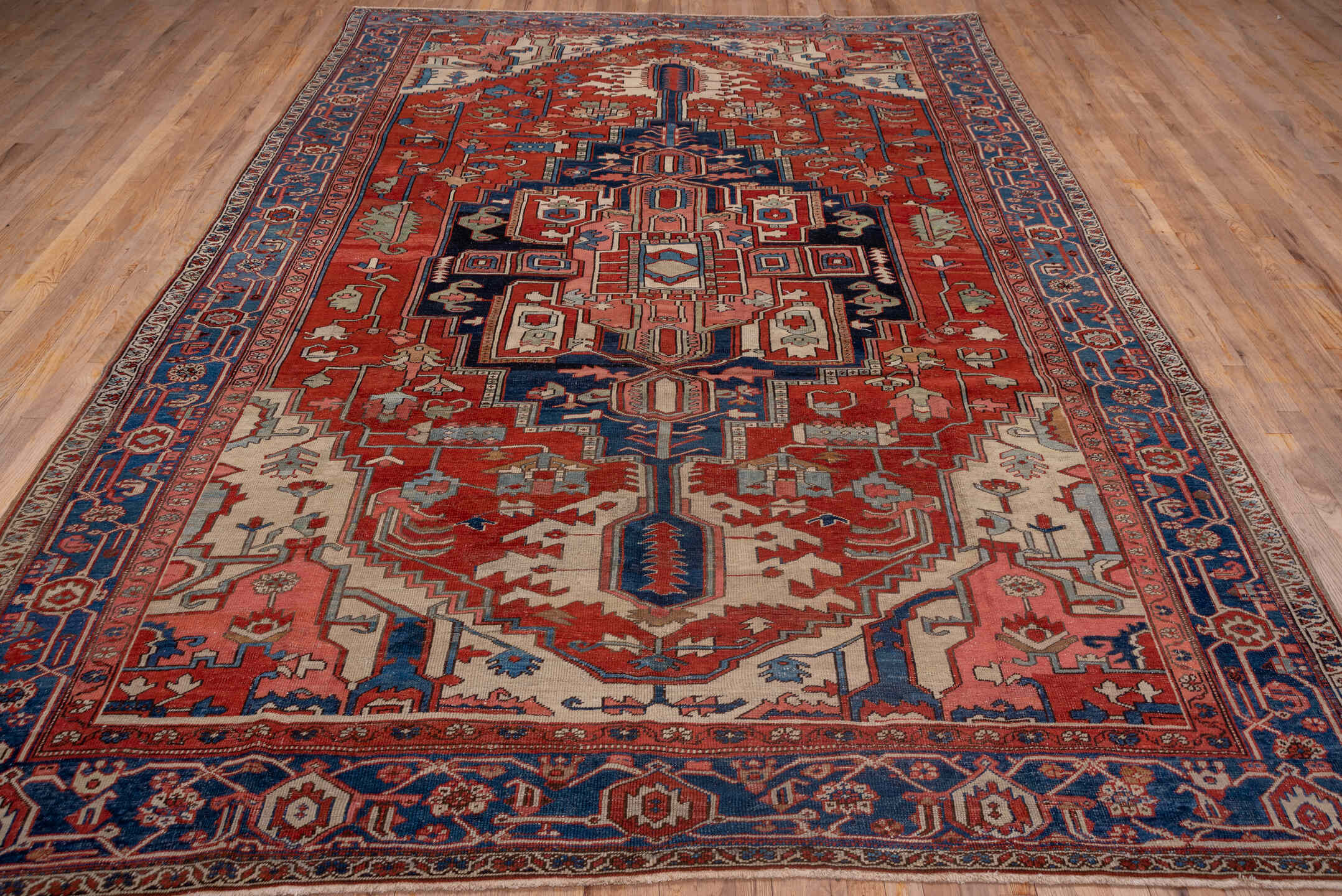 9' x 12' one-of-a-kind handmade vintage Serapi large size rug. Color palette: black, blue, brown, gray, pink, red
