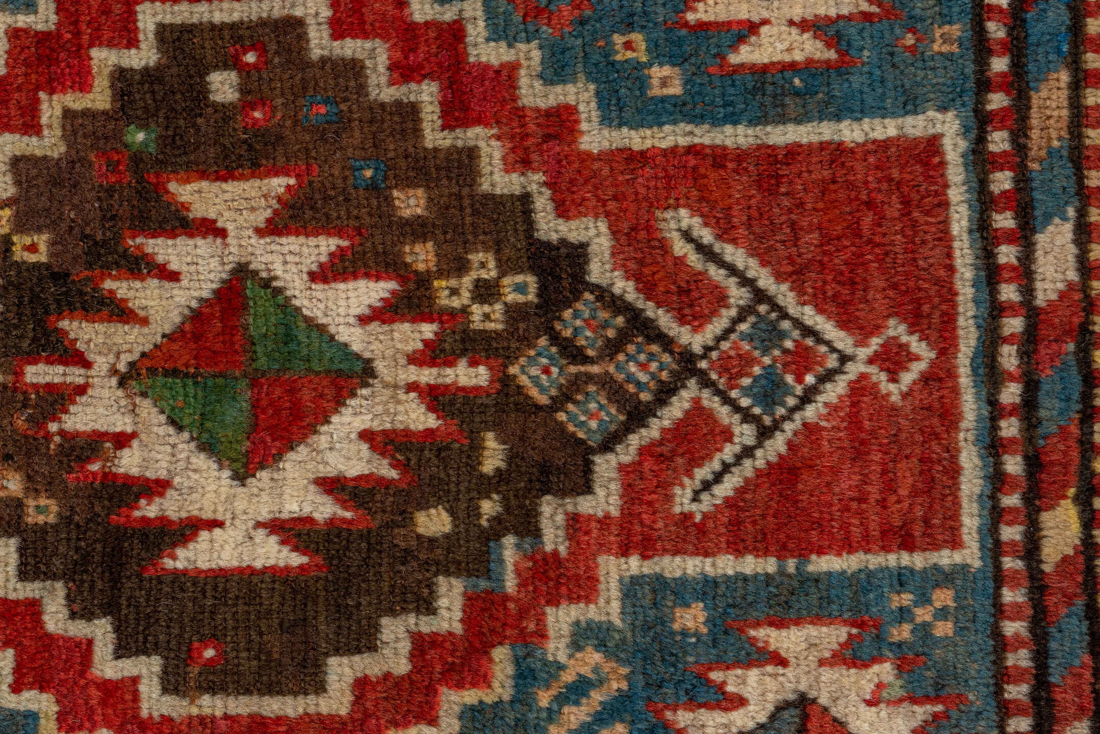 3' x 7' one-of-a-kind handmade antique Kazak rug. Color palette: rust, sky blue, ivory, navy, brown, black, camel, red