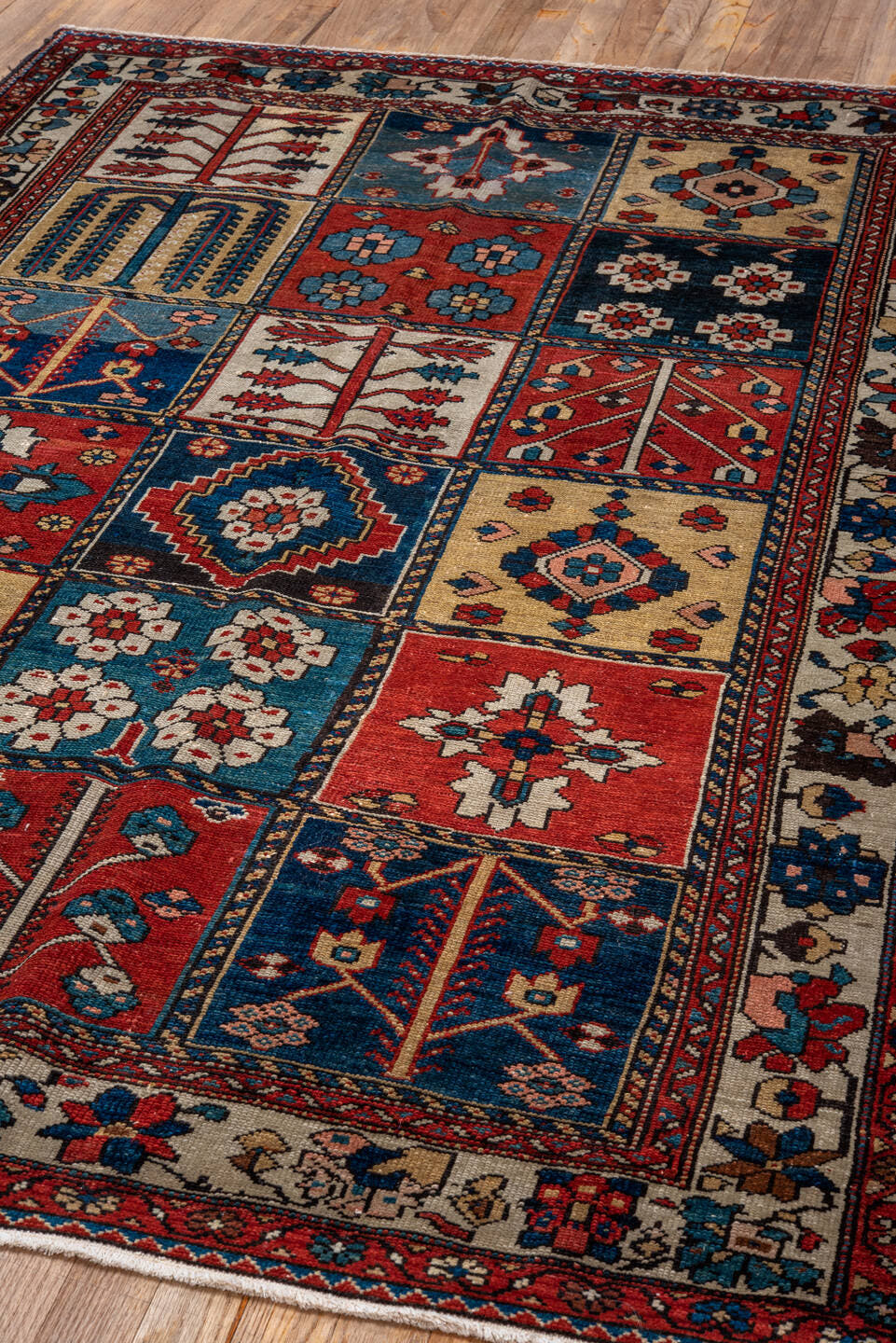 4' x 6' one-of-a-kind handmade antique Baktiary small size rug. Color palette: ivory, red, navy, sky_blue, rust, charcoal
