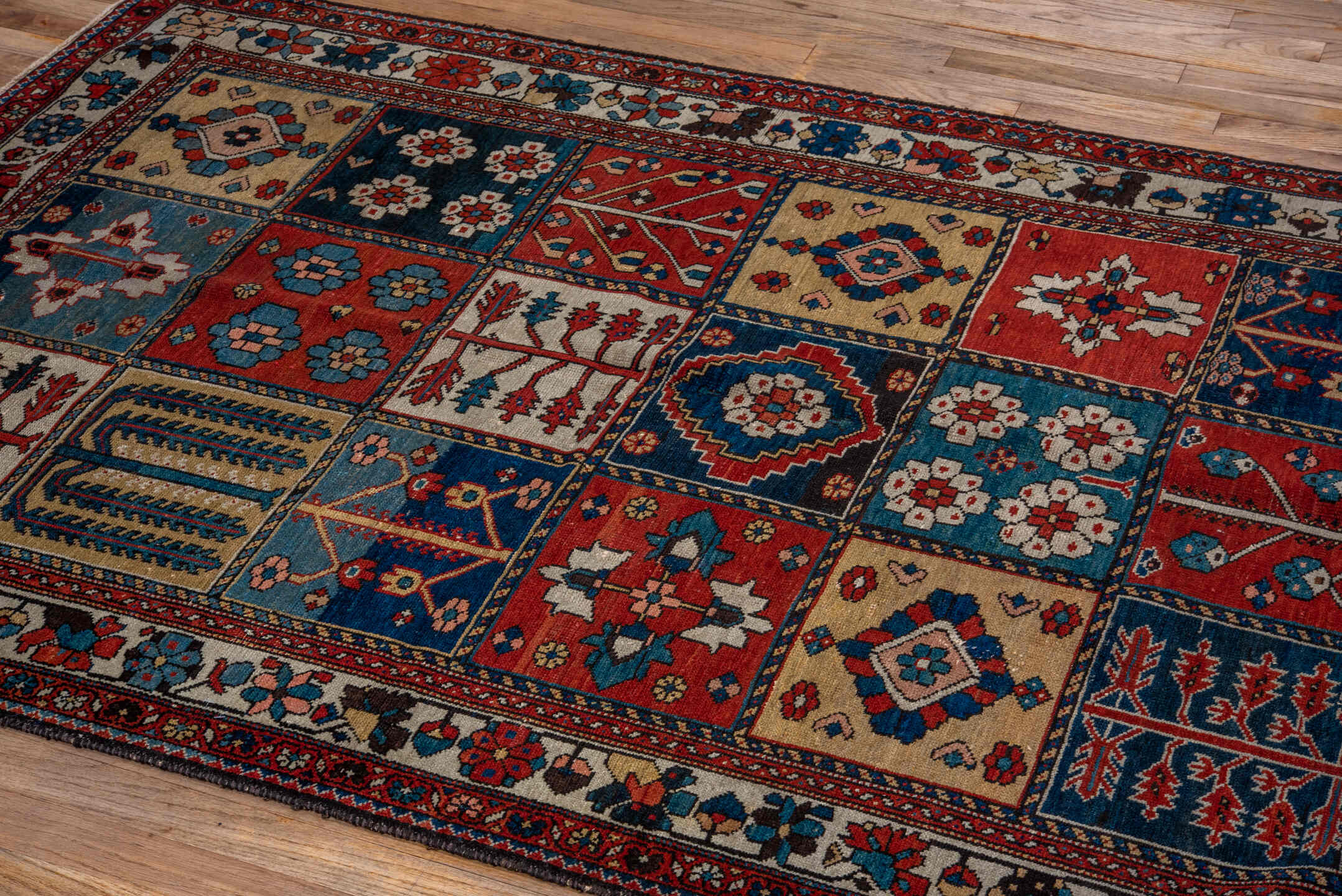 4' x 6' one-of-a-kind handmade antique Baktiary small size rug. Color palette: ivory, red, navy, sky_blue, rust, charcoal