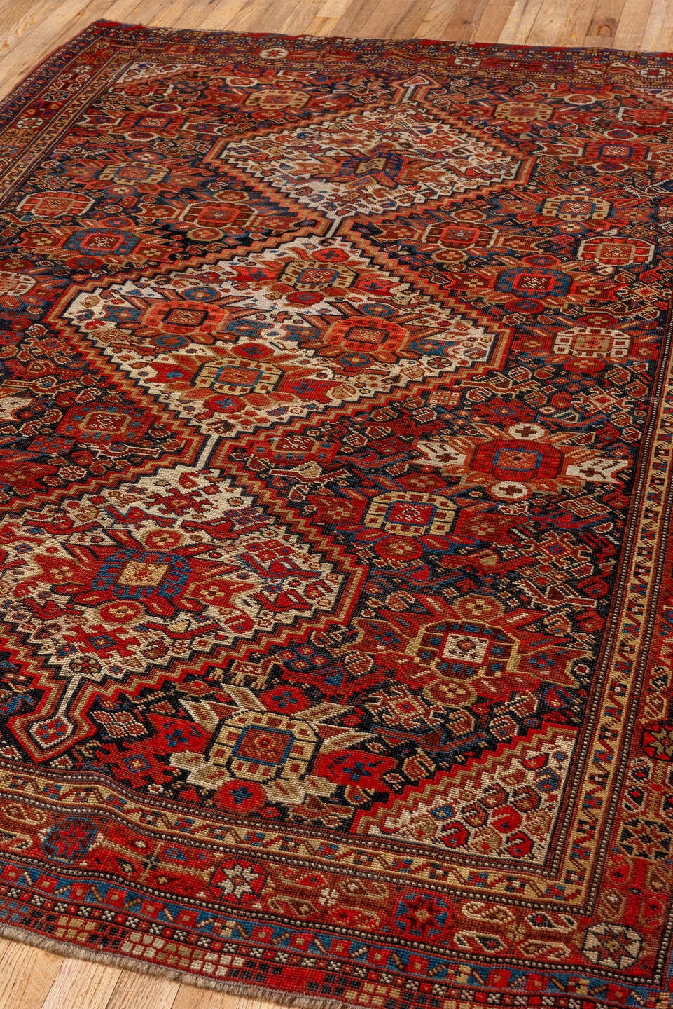 7' x 9' one-of-a-kind handmade vintage Tulu large size rug. Color palette: rust, ivory, navy, crimson, camel, charcoal